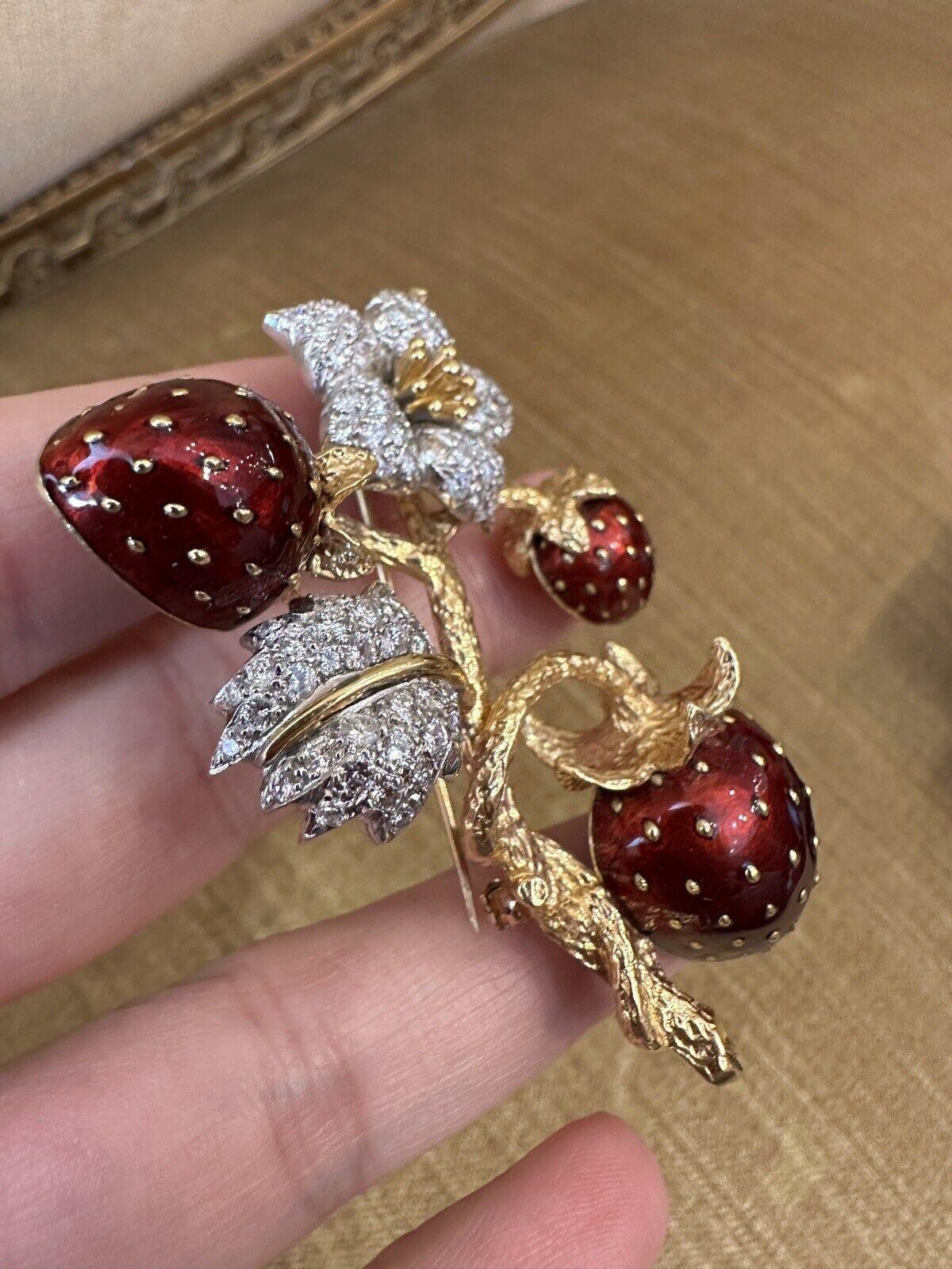 Estate Strawberry Brooch with Diamonds & Enamel in 18k Yellow Gold 

Diamond and Enamel Strawberry Brooch features three Strawberries with Red Enameling and Gold accents on a textured 18k Yellow Gold Stem, with 74 Round Brilliant Diamonds Pavé set
