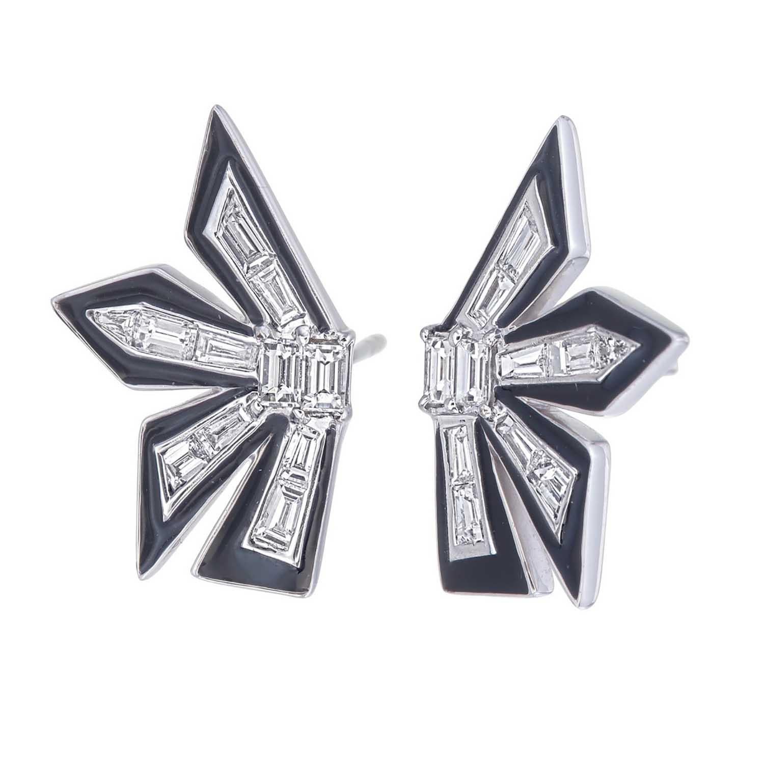 One of its kind earrings crafted in 18kt white gold.
This pair of dynamite earrings are handmade with trillion & baguatte cut diamonds with each diamond recut to bring this fire.
Each spoke is tipped with glossy black enamel to highlight the
