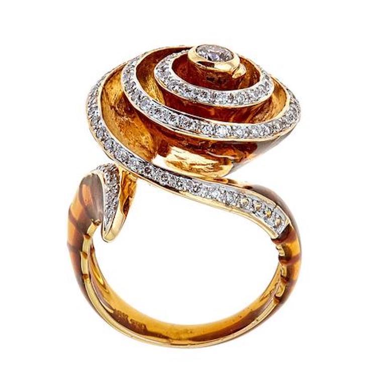 Enameled Wrapped 18 Karat Yellow Gold and 0.69 Carat Diamond Cocktail Ring Size 7

Fashionable design of this cocktail ring just will leave everyone in owe. Round diamonds, together totalling 0.69 TCw,  artfully set in a swirl design with a diamond
