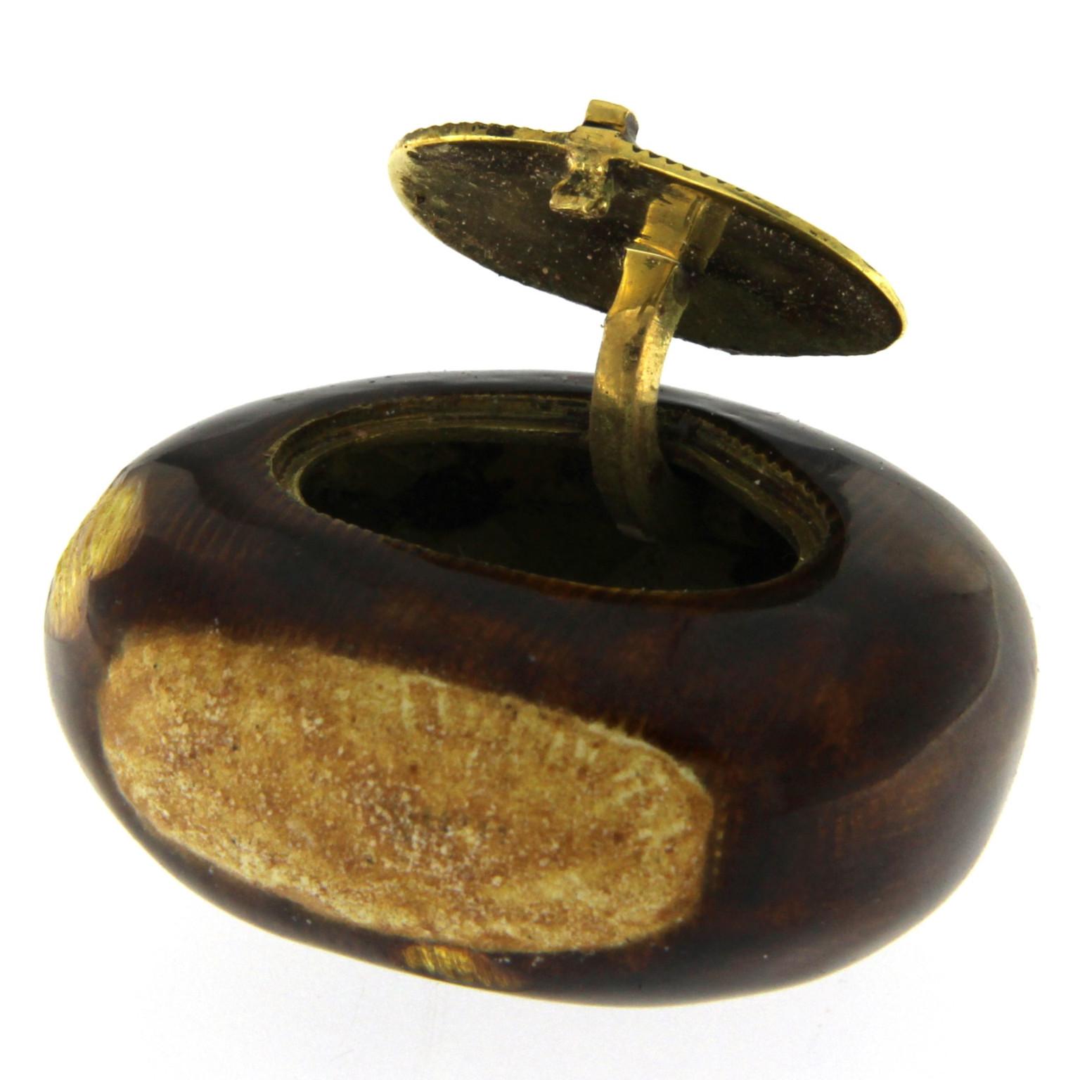 Discover the exquisite charm of this absolutely unusual pill case, meticulously crafted in the shape of a chestnut. This distinctive piece showcases a stunning blend of 18K gold and vibrant enamel, creating a captivating accessory that stands out in