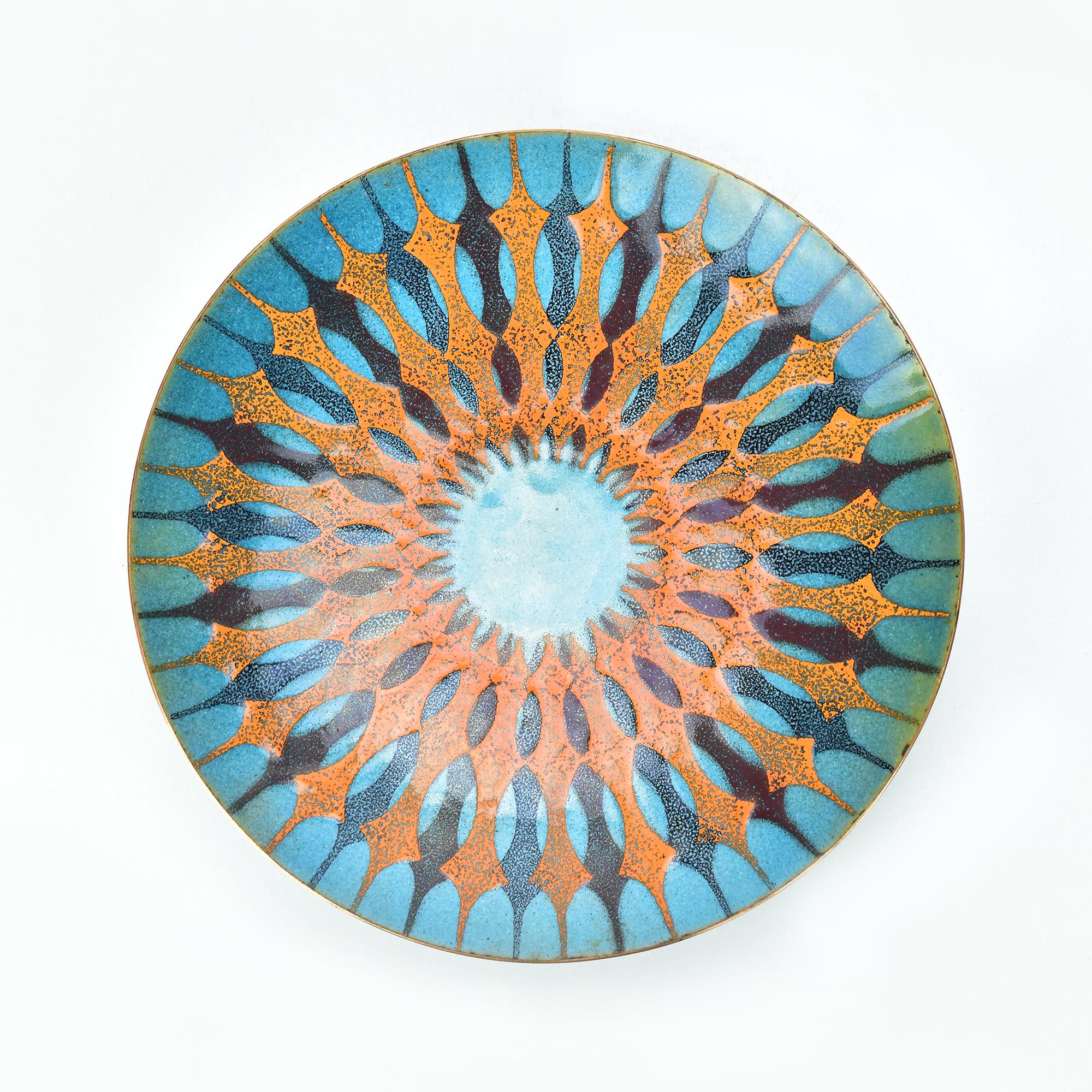A modernist copper bowl with geometric enamel decoration by Margarete Ernst from the 1960s.

Margarete Ernst was a notable artist and designer known for her work in metal and enamel during the mid-20th century. Her creations often reflect the