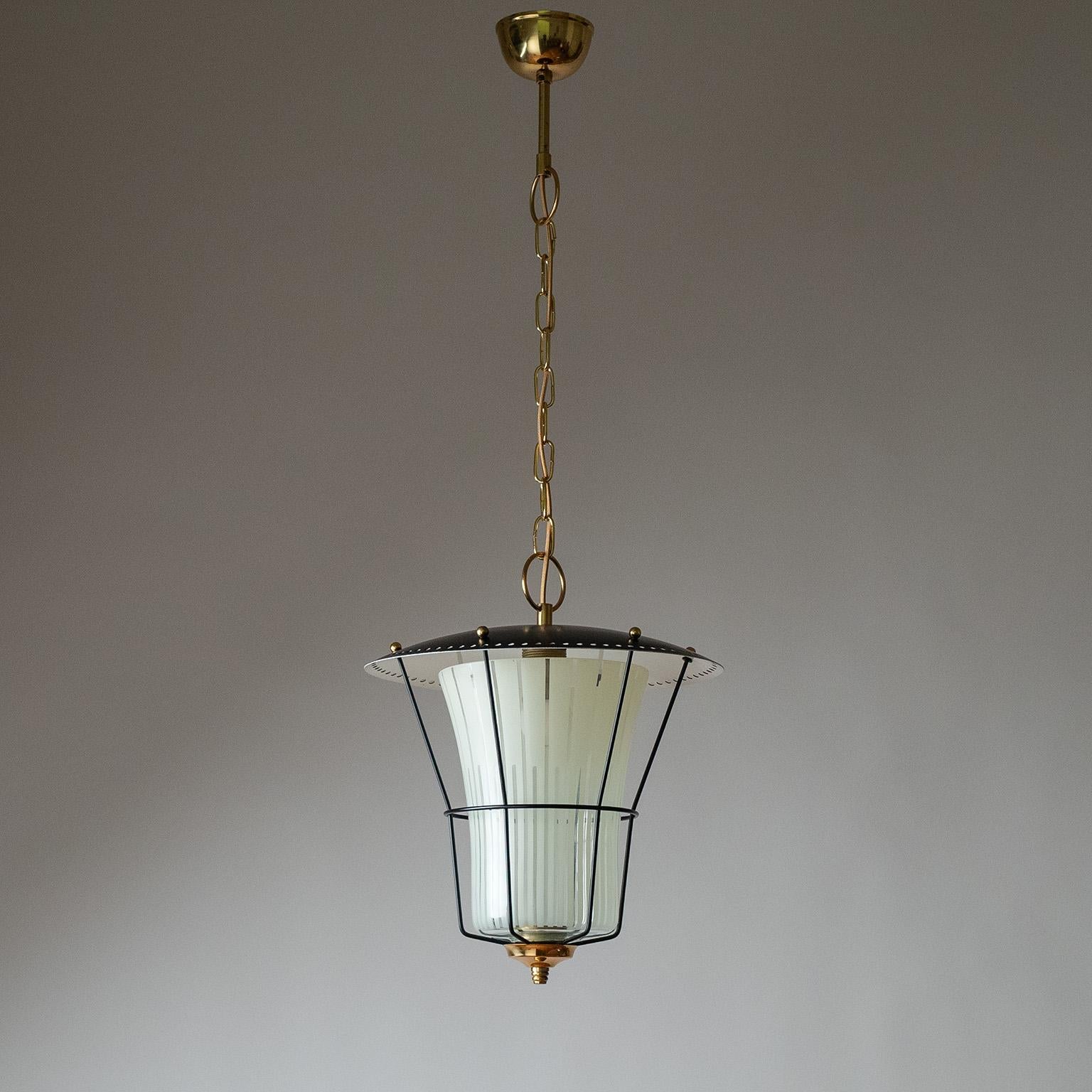 fine Mid-Century Modern lantern from the 1950s. Pierced shade with a delicate cage structure which houses a down glass diffuser with off-white enameled stripes. Very good original condition with minimal patina. One original brass E27 socket with new
