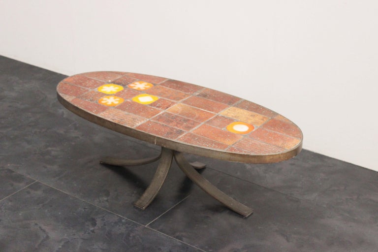 Coffee table, top decorated in enameled lava stone, metal legs of generous thickness, the color in the picture is original.