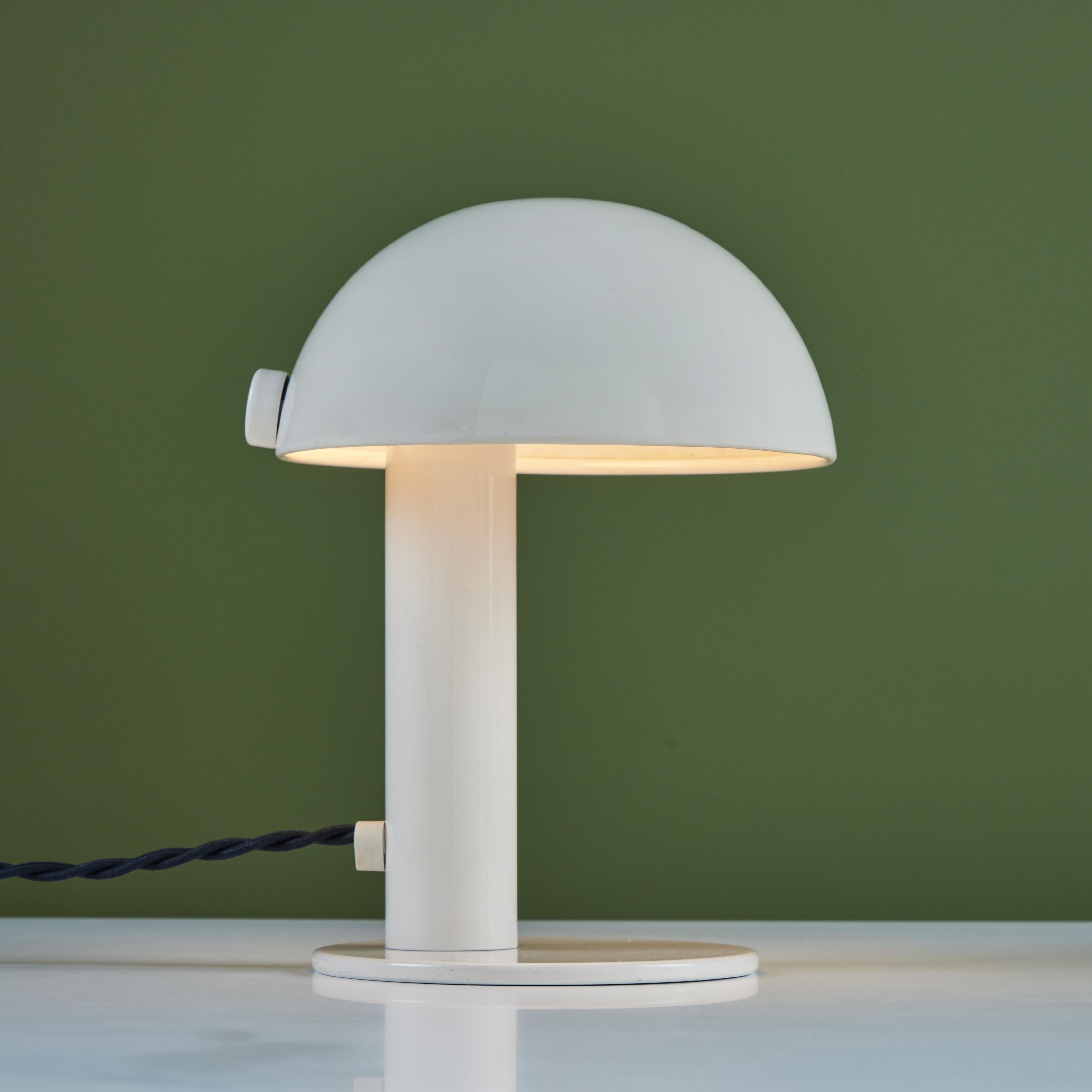 Petite table lamp with mushroom lampshade in cream-enameled metal. A round base in matching cream anchors the lamp with its tubular stem.

Dimensions
7