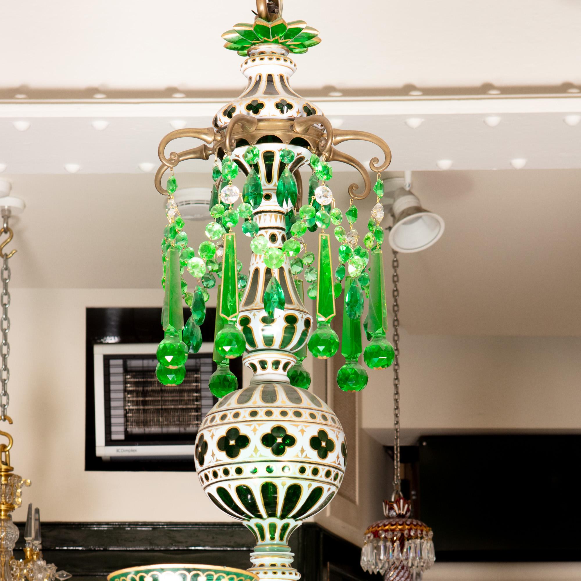 A late 19th century emerald green and white overlay chandelier by F. C Osler for the Indian market. The central shaft supporting central spheres below a canopy of massive emerald green drops, the receiver bowl issuing 12 green over clear cut glass