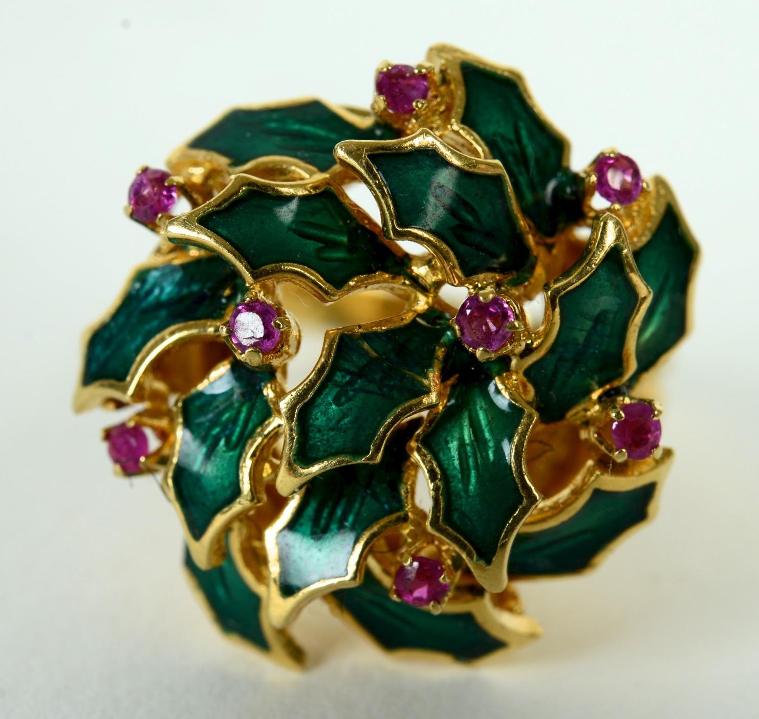 Enameled Ring with Holly and Berry Decoration Set with Pink Topaz in 18K Gold. The enamel with carved green leaves and 8-2mm prong set round dark pink topaz. The ring is hallmarked with a maker's mark and 