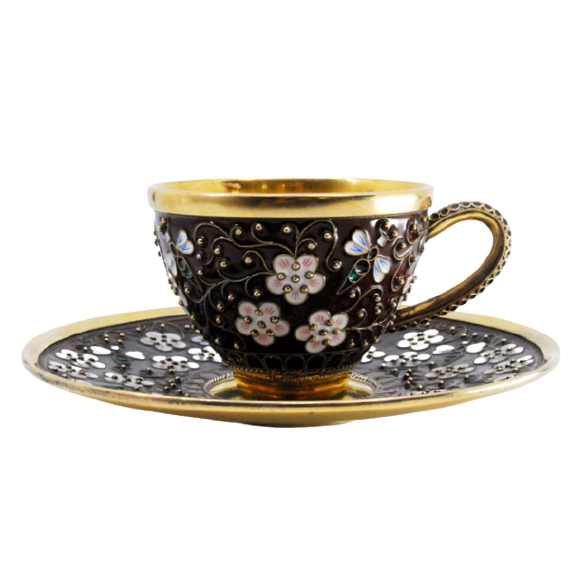 Enameled silver cup and saucer with floral motifs and gold interior