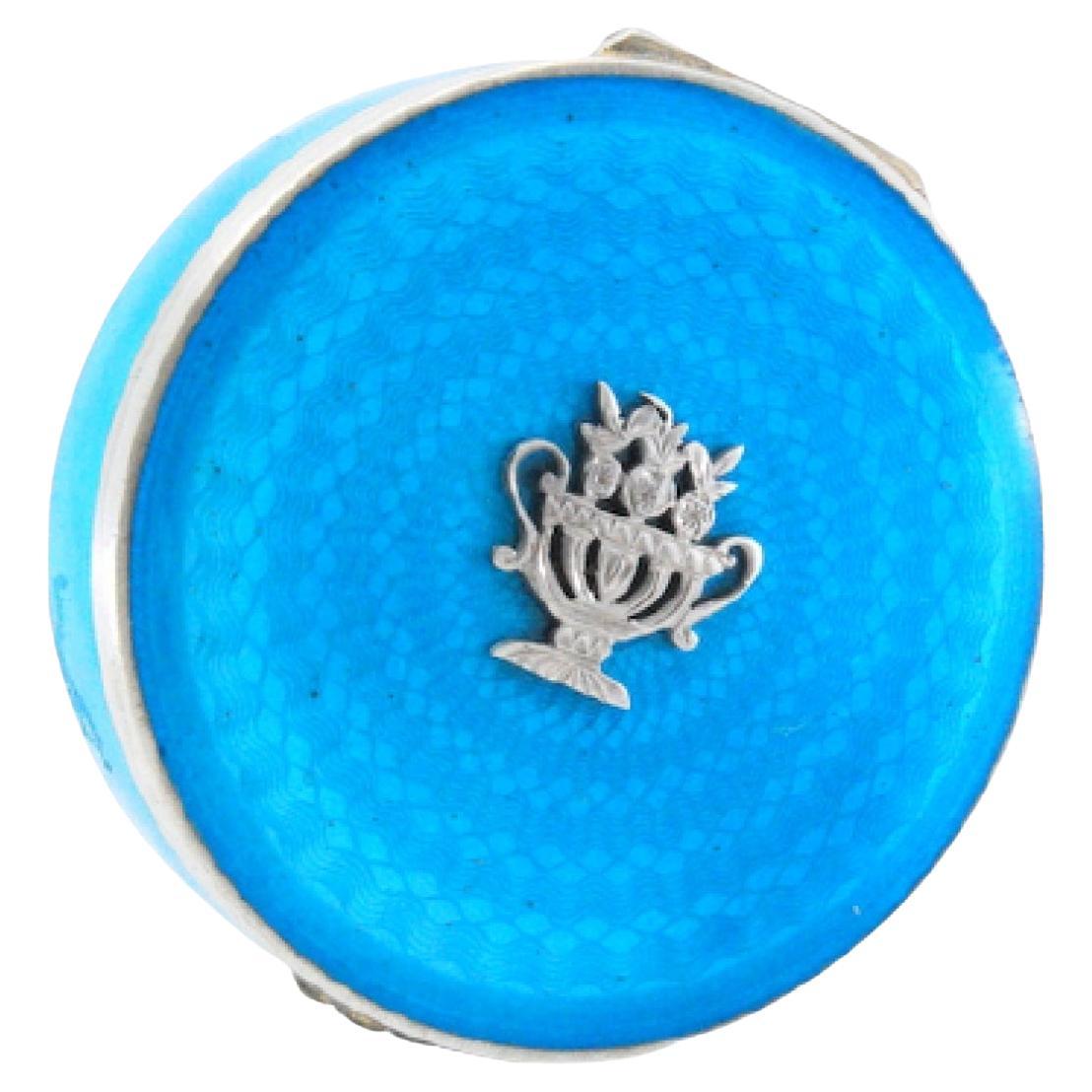 Enameled silver pill box with a bouquet of flowers in relief on the hinged lid