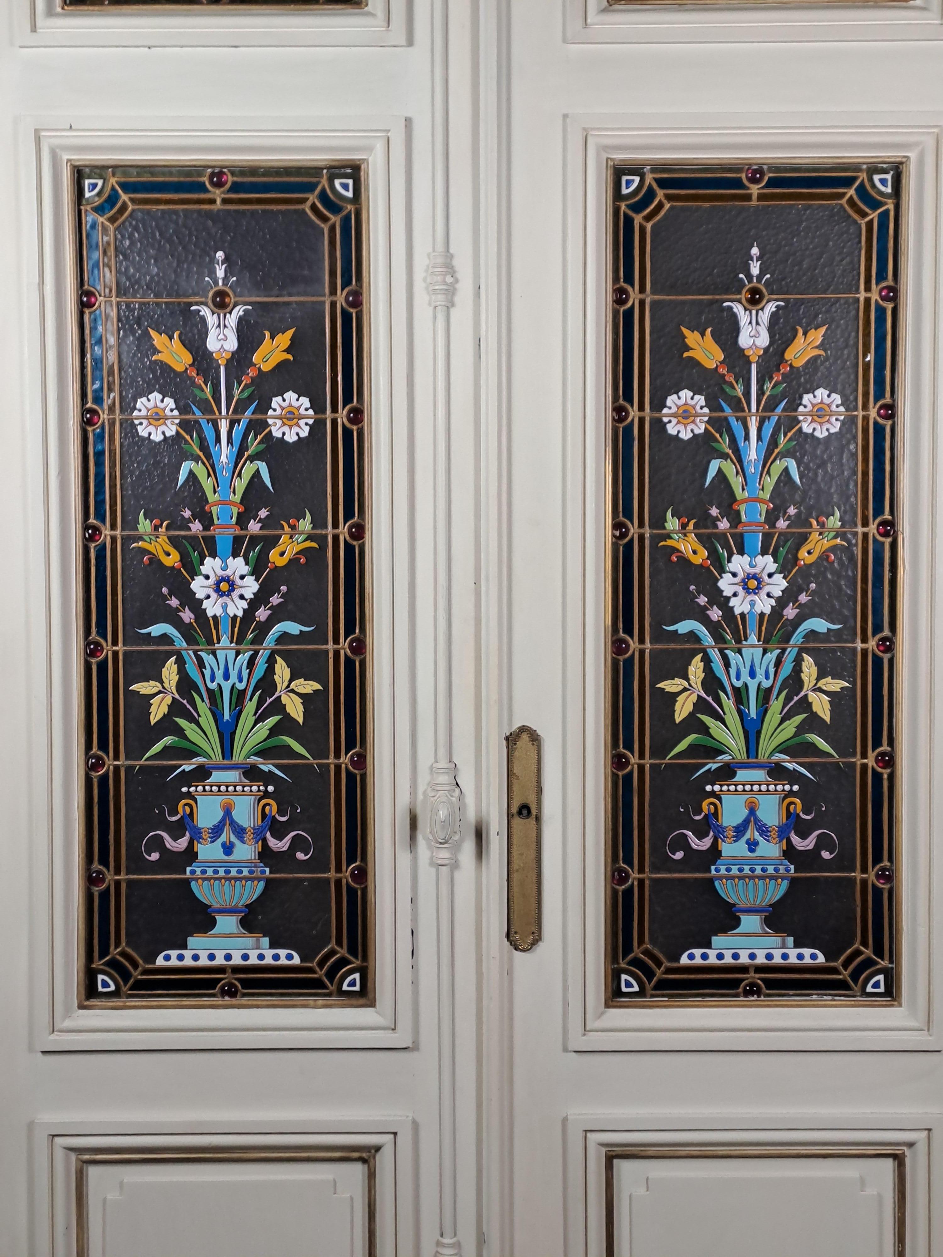 Superb set of four stained glass windows with polychrome enamel decoration mounted on a double interior communication door.

Beautiful decoration of stylized vases.

The advantage of enameled stained glass is that it does not require back lighting