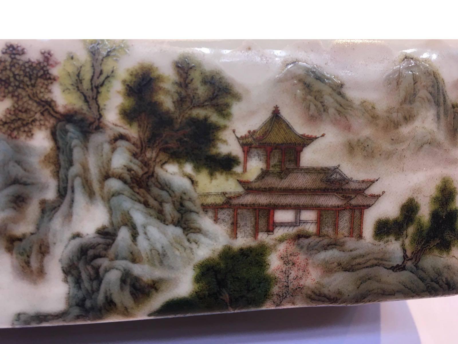 Republic period, cyclically dated dinghai year, corresponding to 1947 and of the period
The rectangular porcelain weight finely enamelled with a mountainous landscape with pavilions and rivers, with a seven-line poetic inscription, with date and