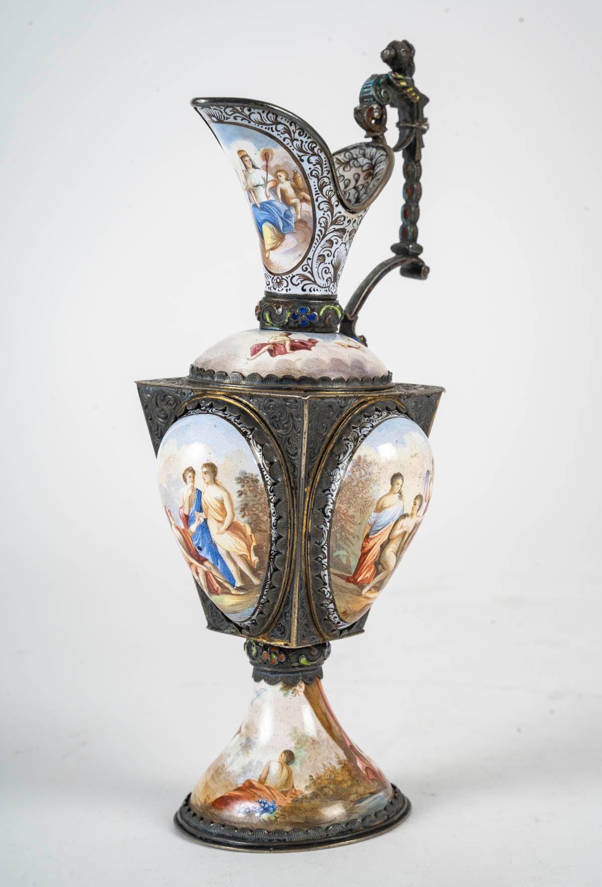 Enamelled silver ewer, 19th century, Napoleon III period.

A Napoleon III period silver ewer, 19th century, decorated with enamel paintings of antique scenes.
h: 18cm, w: 8.5cm, d: 7.5cm