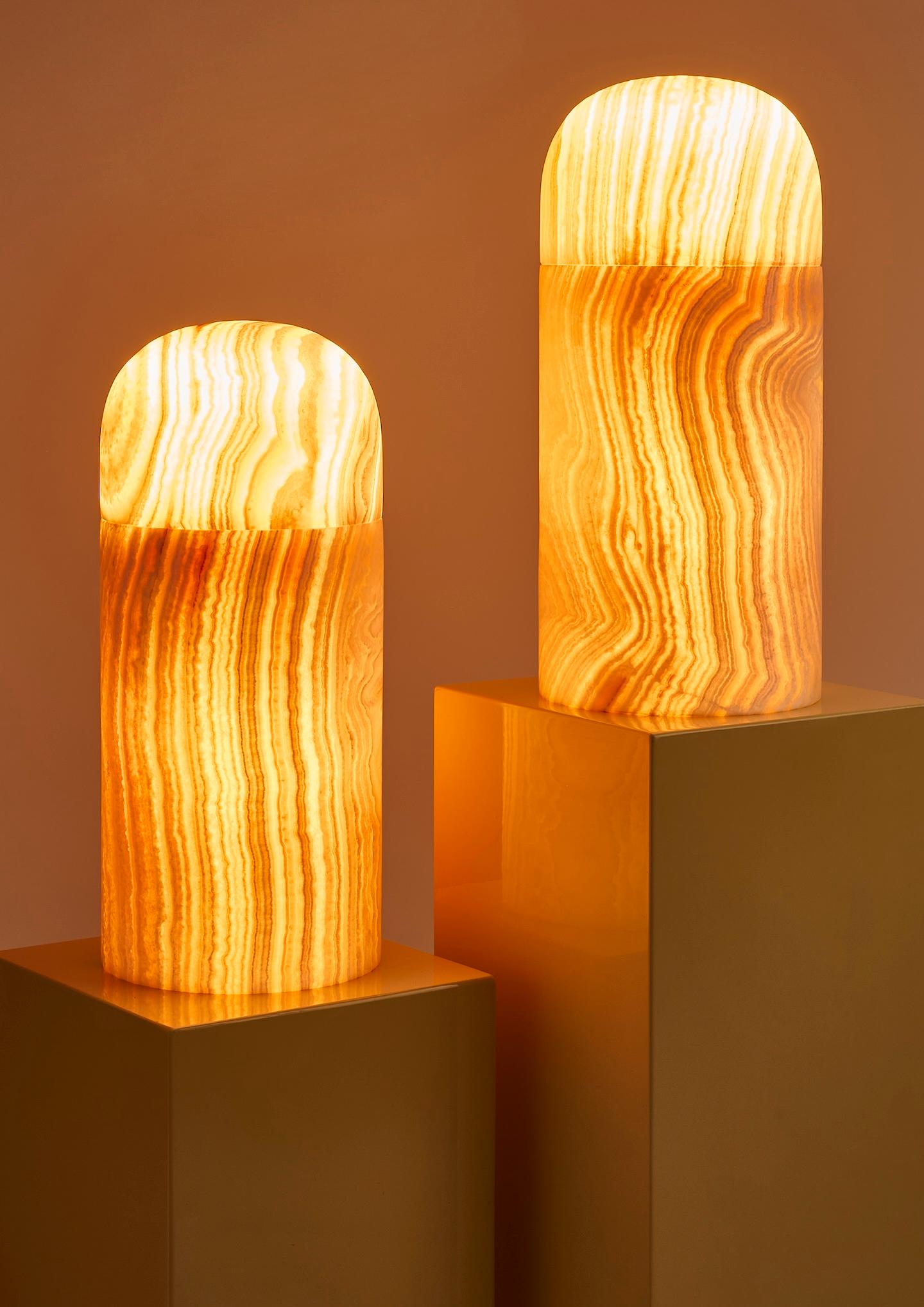 A luminous ode to the past and future, the Encapsulated Table Lamp takes inspiration from the symbolic form of a time capsule – an object created to carry messages across generations. Carved by hand from richly veined Alabaster, the lamp radiates a