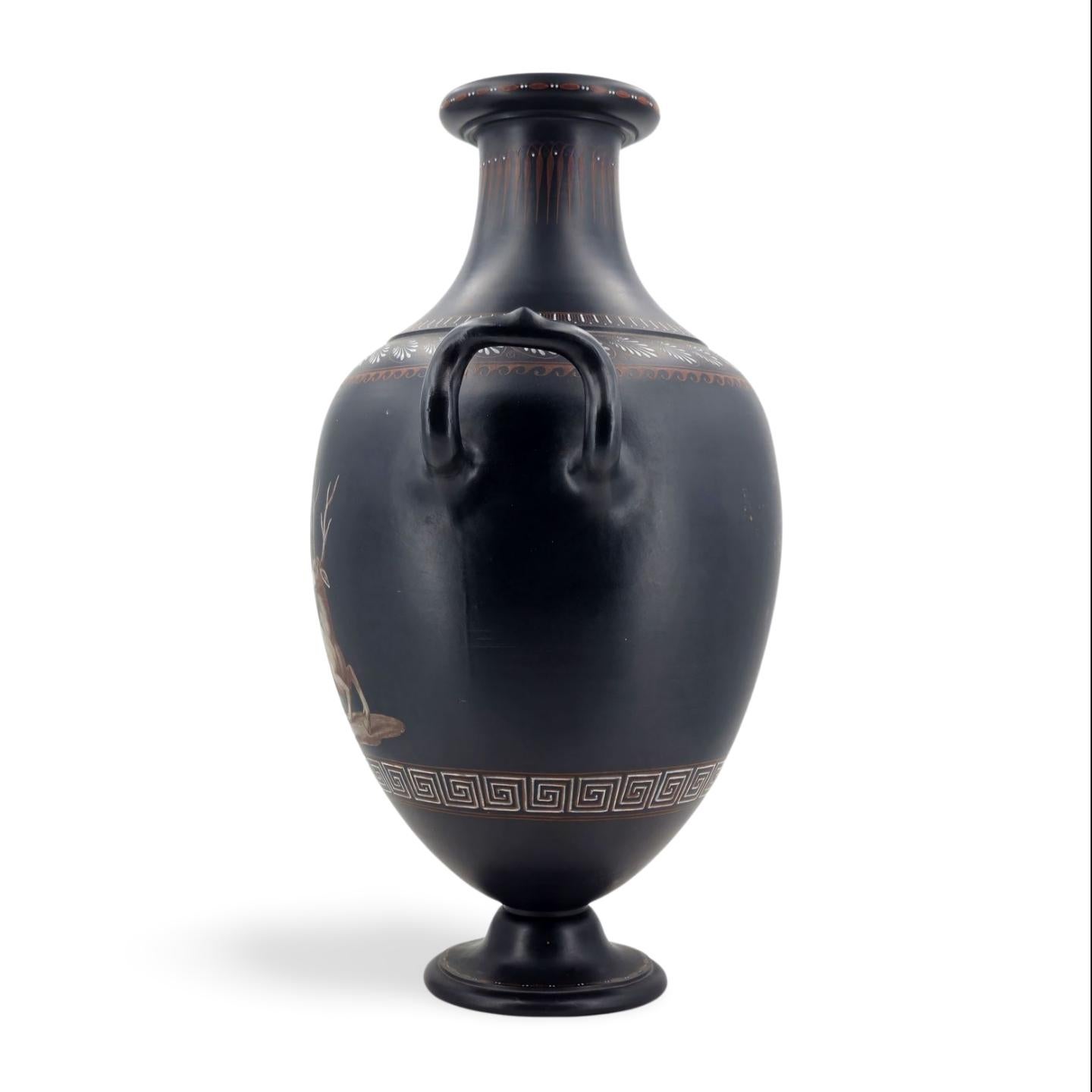 A fine, large vase in black basalt, decorated with an en grisaille painted illustration of Orpheus playing his lyre, with a stag sitting quietly by, listening to his playing - and perhaps singing, although his mouth is shown closed.


Orpheus's