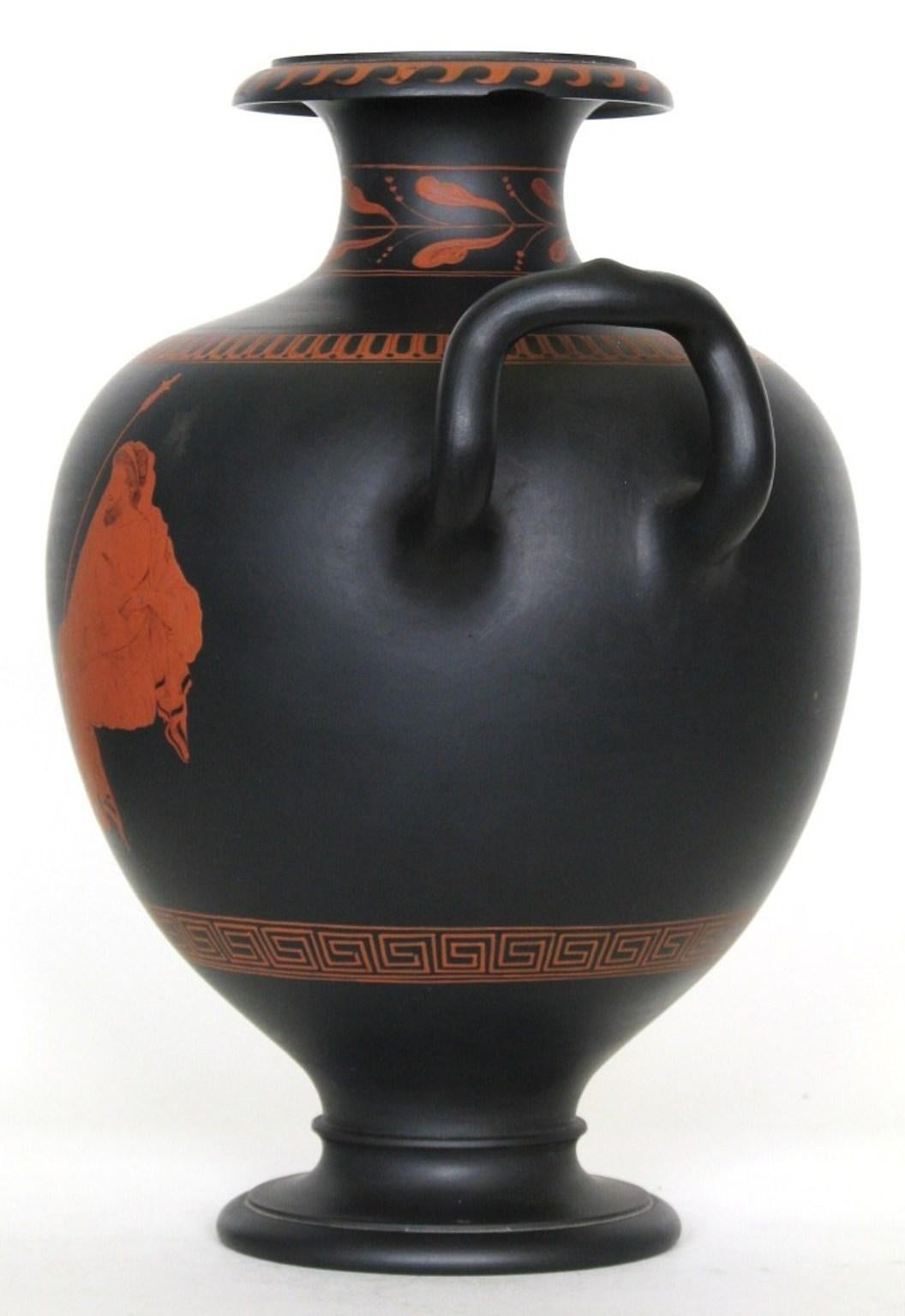 A fine, large vase in black basalt, decorated with an encaustic painted figure of a youth and an older man, taken from The Hamilton vase in the British Museum. It is unusual to find an example made and fired as a single piece, a sign of early