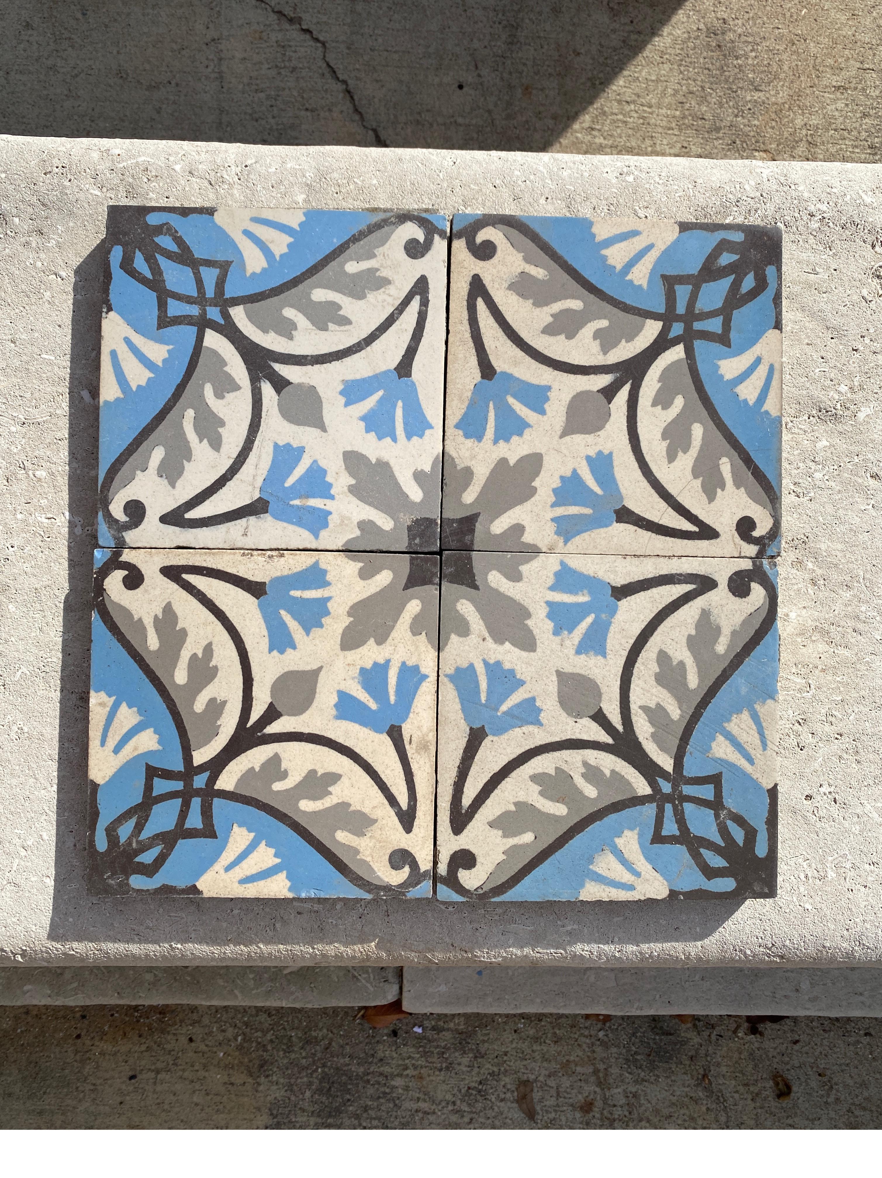 Beautiful blue and grey encaustic tiles with small flowers.