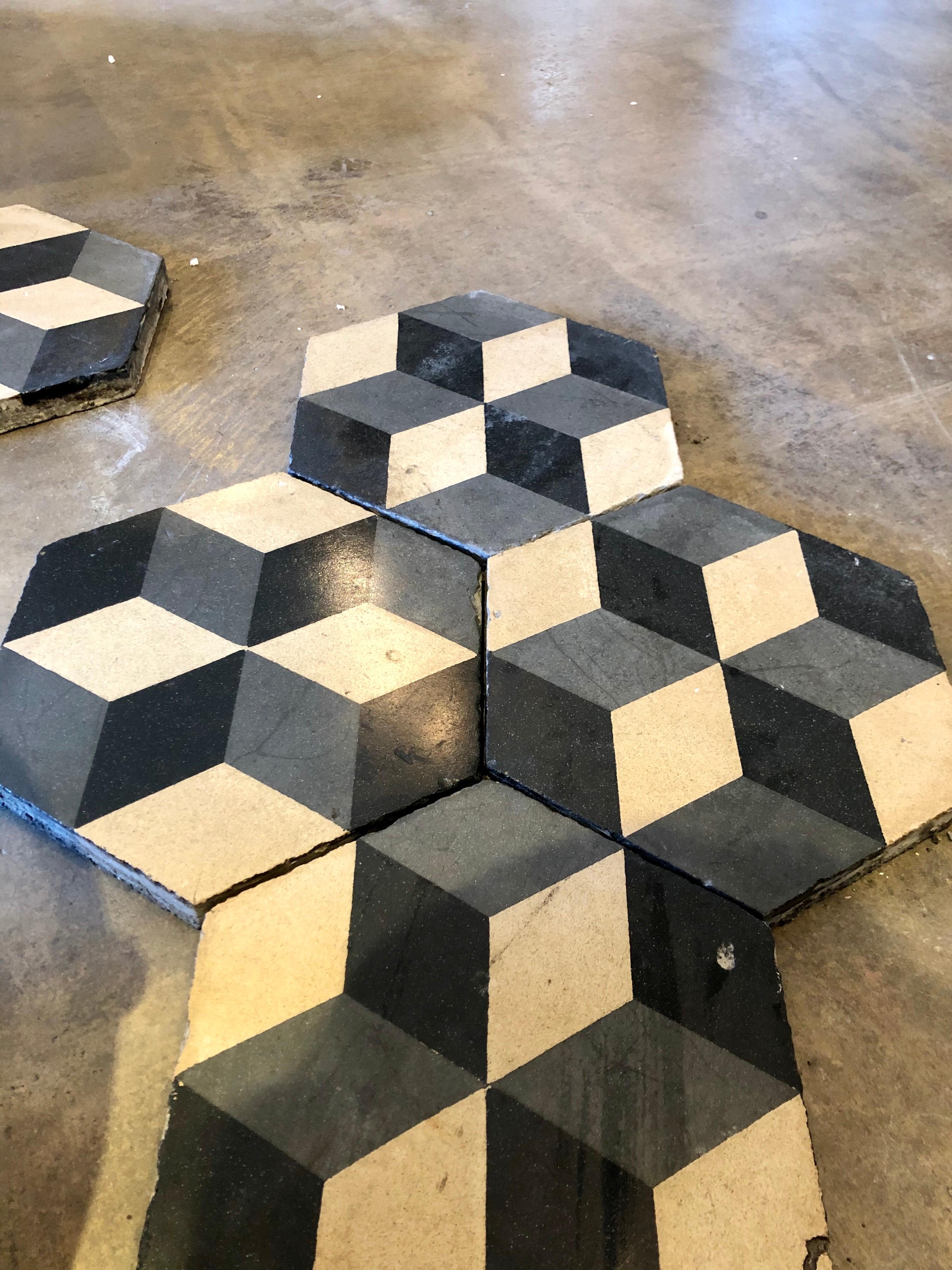 Black and white encaustic tiles.

We have 160 sq ft of those tiles.

We only sell the entire lot. 