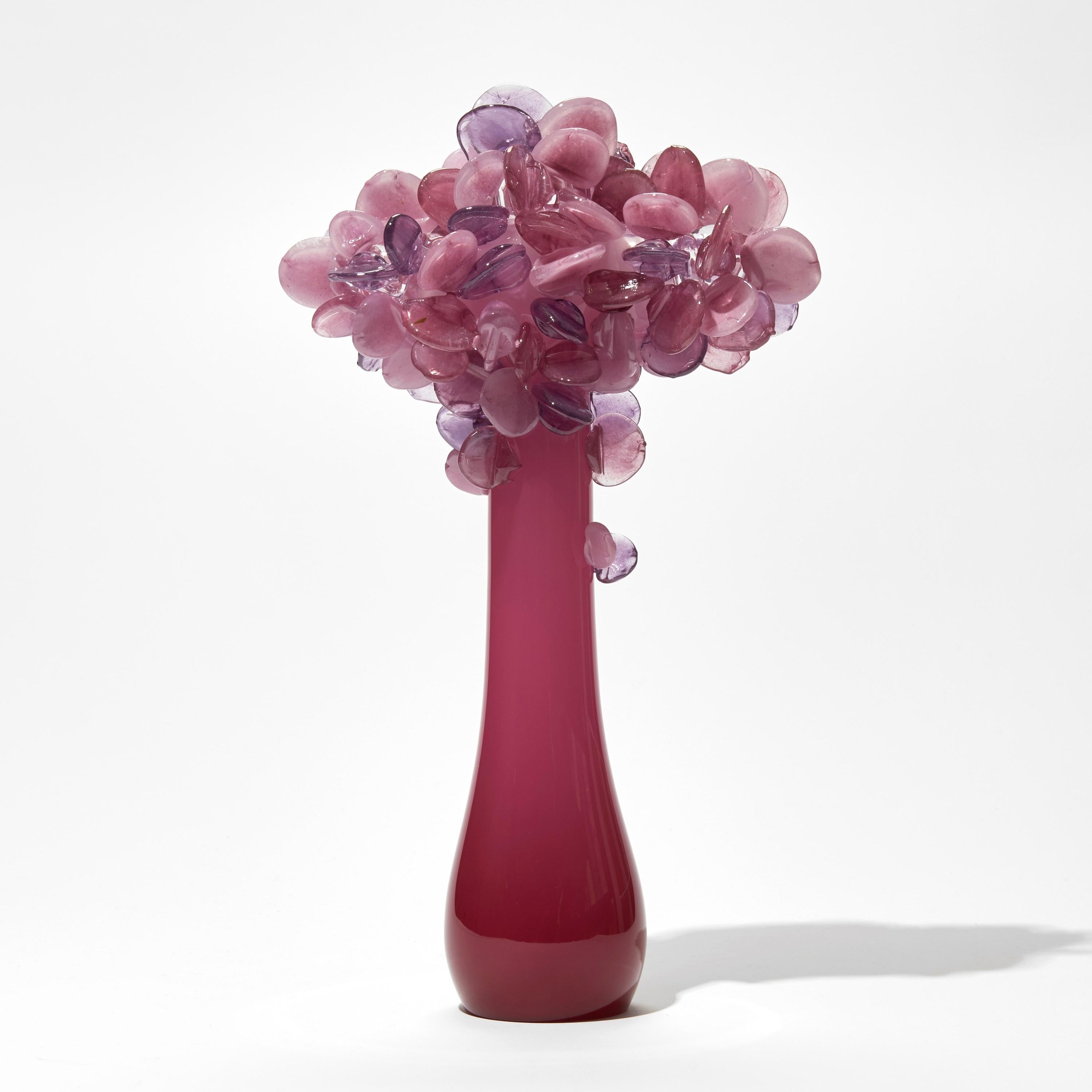 Enchanted dawn in Fuchsia is a unique pink glass tree sculpture by the British artist Louis Thompson. 

With both his Enchanted Dawn and Dusk collections, Thompson brings a joyous and playful element to his glass. Gracious sweeping trunks are