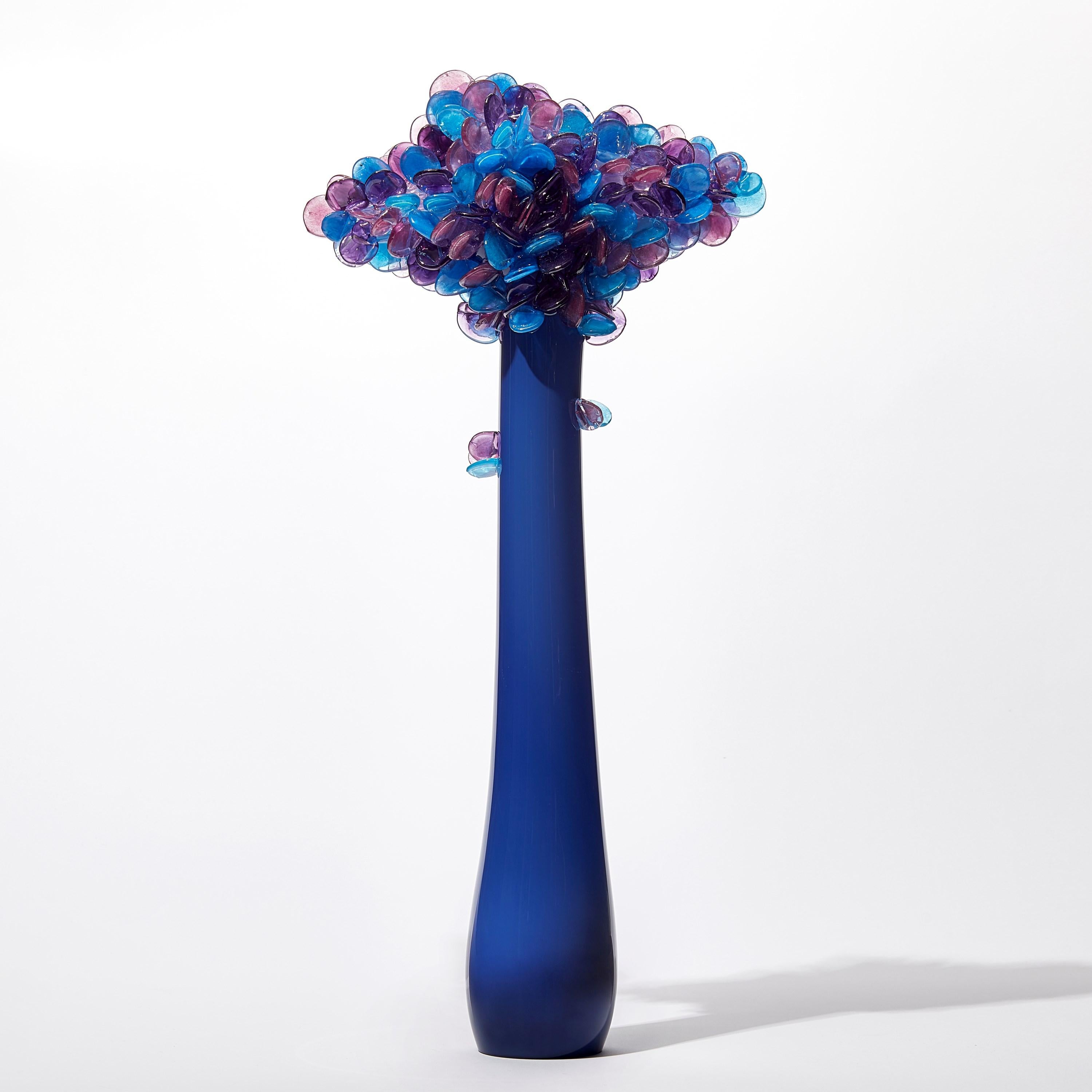 'Enchanted Dawn in Iron Blue III' is a unique handblown and sculpted glass artwork by the British artist, Louis Thompson.

With both his Enchanted Dawn and Dusk collections, Thompson brings a joyous and playful element to his glass. Gracious