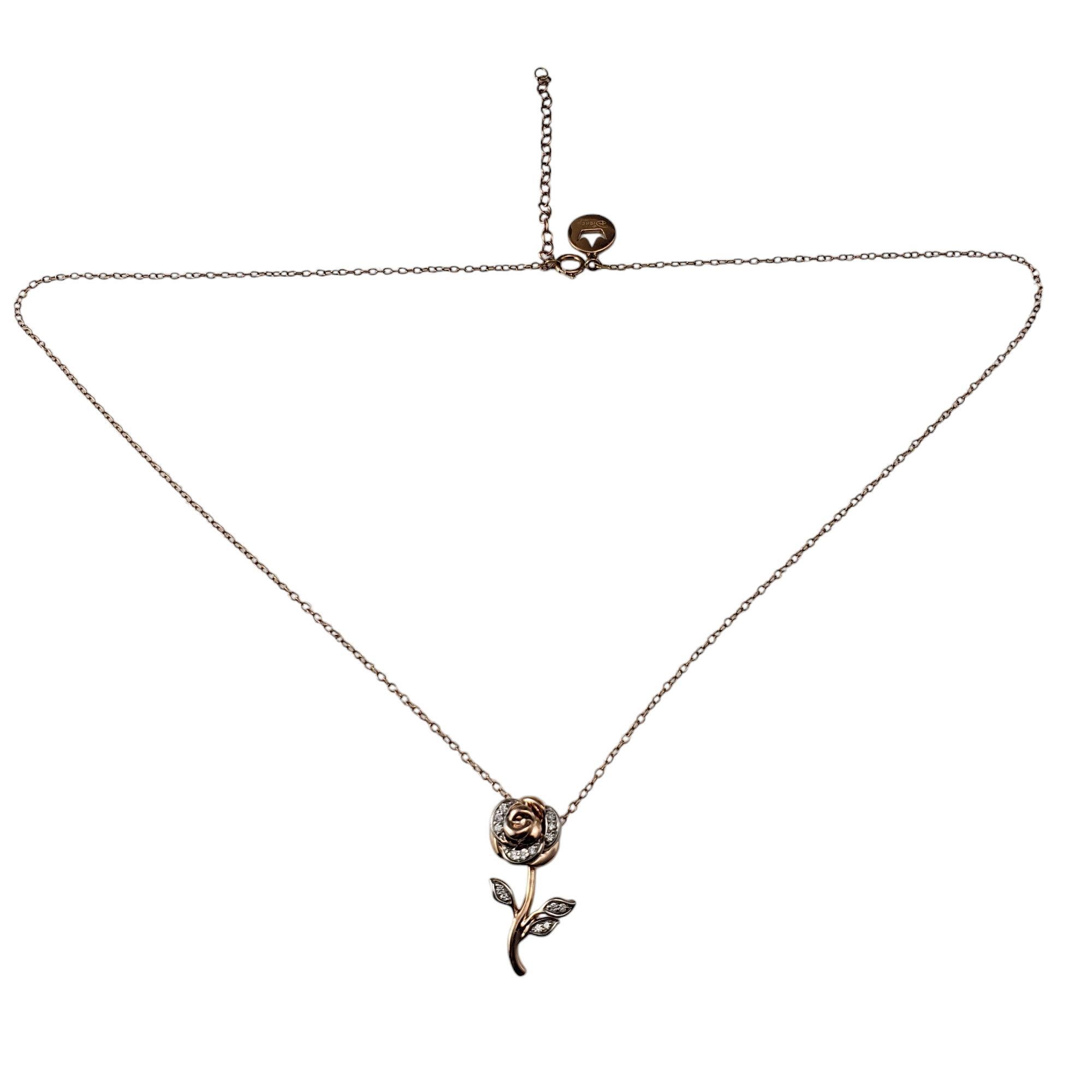 Enchanted Disney Belle 10K Rose Gold and Diamond Rose Pendant Necklace-

This captivating pendant, inspired by Disney's Beauty and the Beast, features a sculpted blooming rose adorned with diamonds along its petals and leaves. Suspends from a