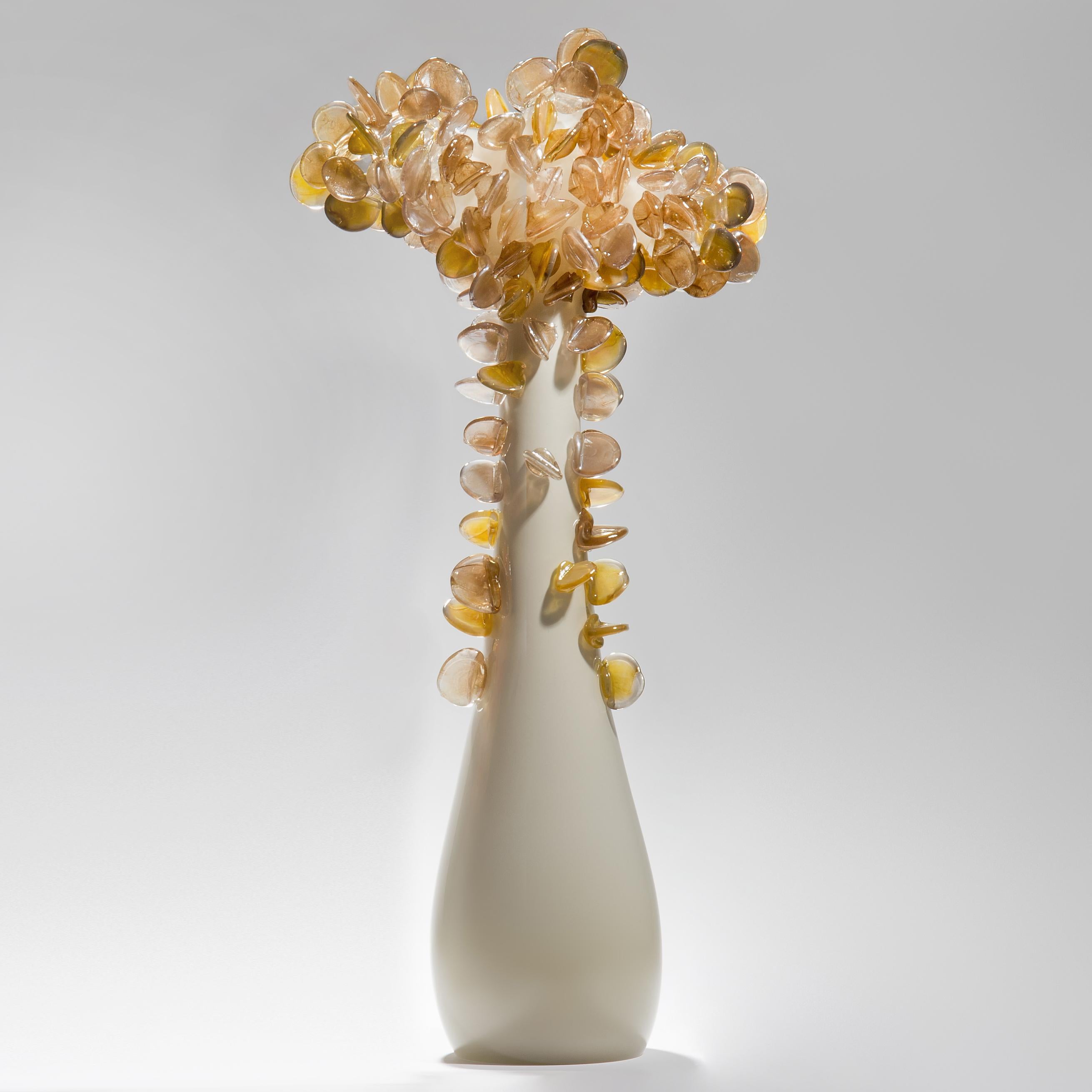 Enchanted Dusk in tall bronze, is a unique glass tree sculpture by the British artist Louis Thompson. The initial tree trunk form has been handblown in clear and taupe coloured glass. The top has been covered in free-hand sculpted leaves, each