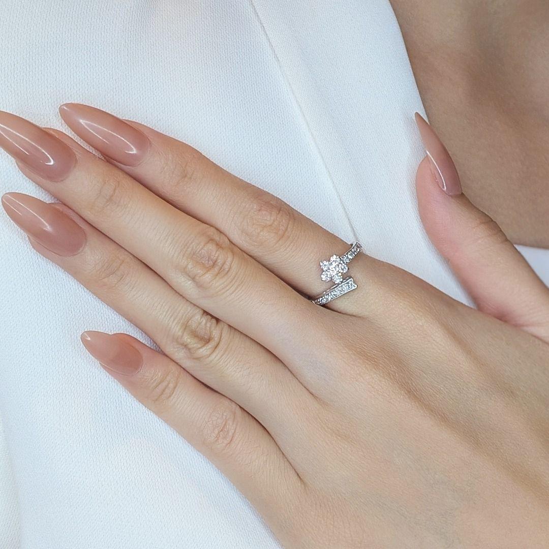 Delight in the enchanting beauty of this 0.34ct floral diamond ring, a perfect fusion of elegance and nature-inspired design. Crafted in luxurious 18K white gold, this exquisite piece features 17 round brilliant natural diamonds, carefully arranged