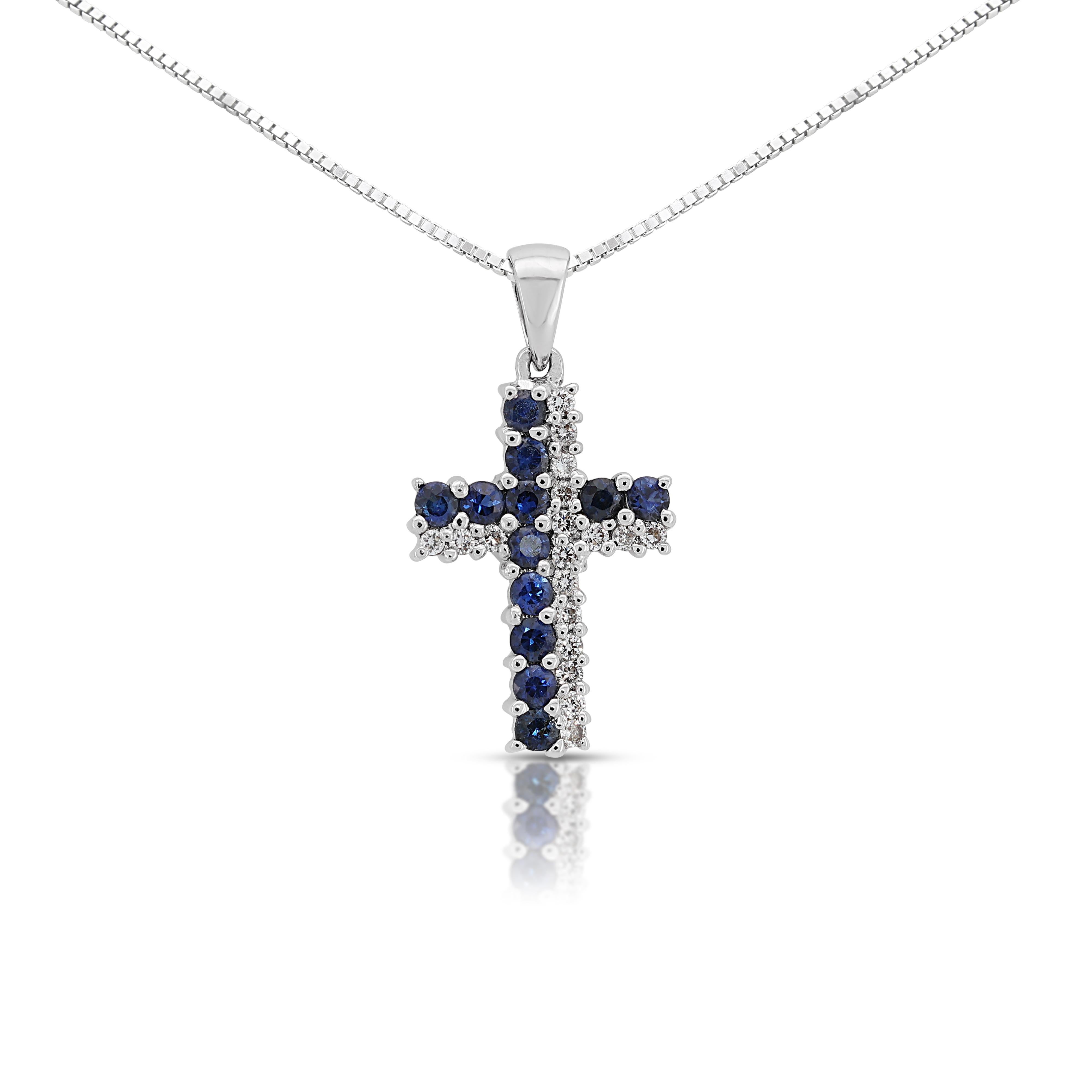This enchanting cross pendant features a dazzling display of gemstones, meticulously set in gleaming 18K white gold. The centerpiece showcases 12 captivating round brilliant sapphires boasting a combined weight of 0.42 carats and a mesmerizing blue