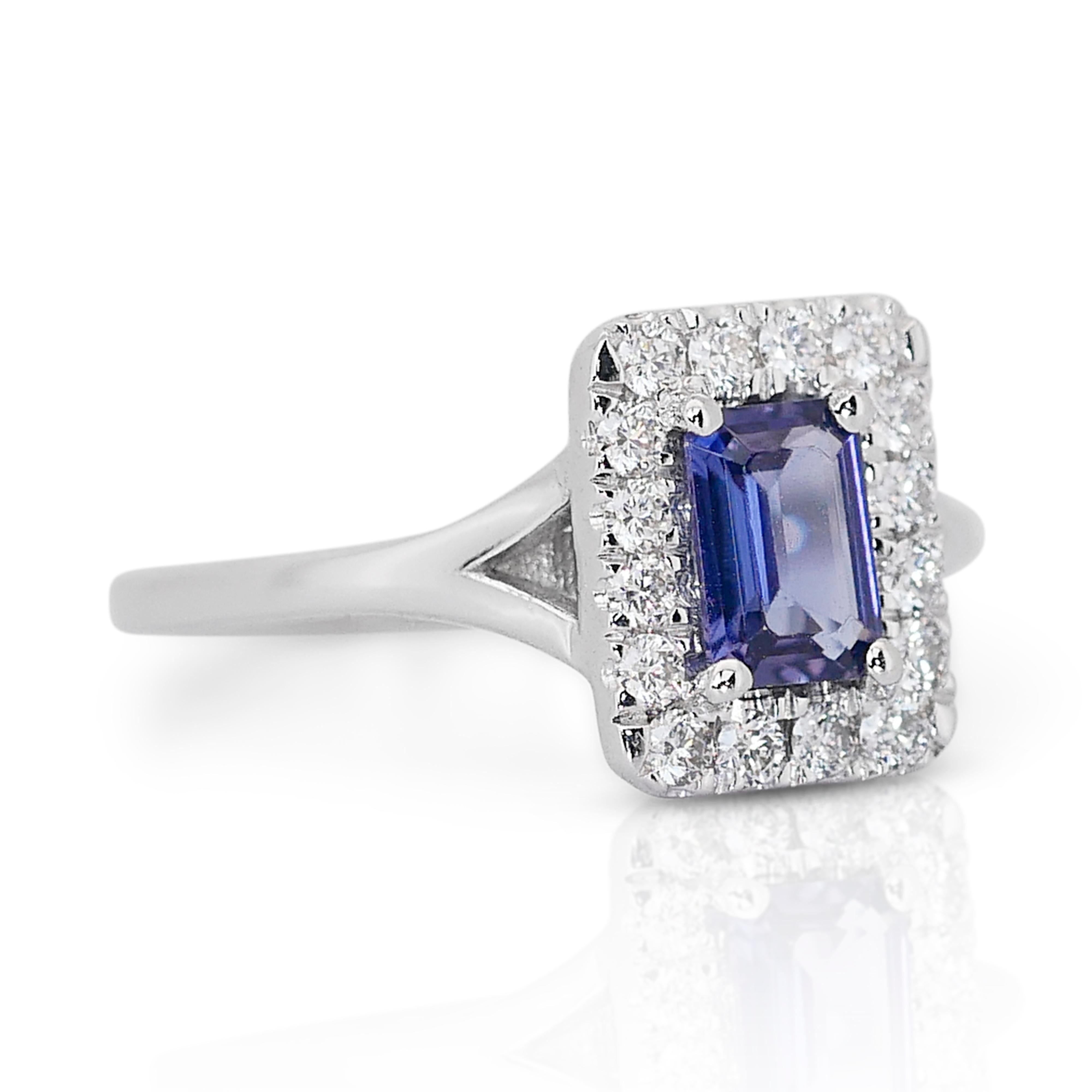 Enchanting 0.93ct Tanzanite and Diamonds Halo Ring in 18k White Gold - IGI Certified

This stunning halo ring in 18k white gold features a rare 0.60-carat emerald-cut diamond in a unique violetish-blue color. Encircling the main stone, 16 round