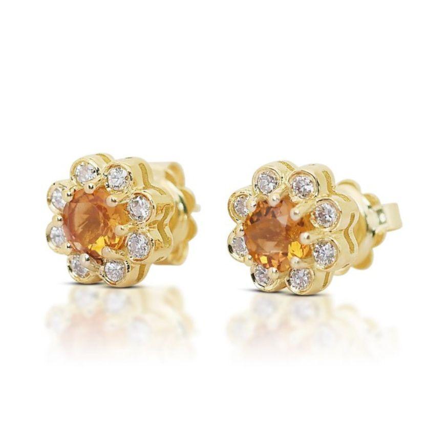 These enchanting earrings feature two captivating quartz main stones, weighing 0.82 carats and cut into a mesmerizing round mixed cut. The intense yellow-orange hue of the quartz adds a vibrant burst of color to any ensemble, radiating warmth and