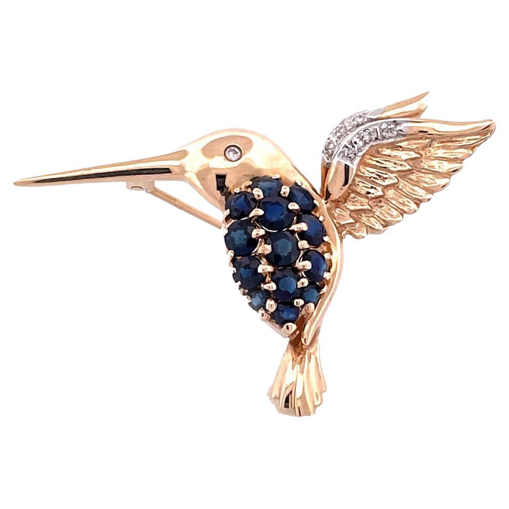 Enchanteresse broche oiseau en or jaune 14 carats avec saphir et diamants en vente
