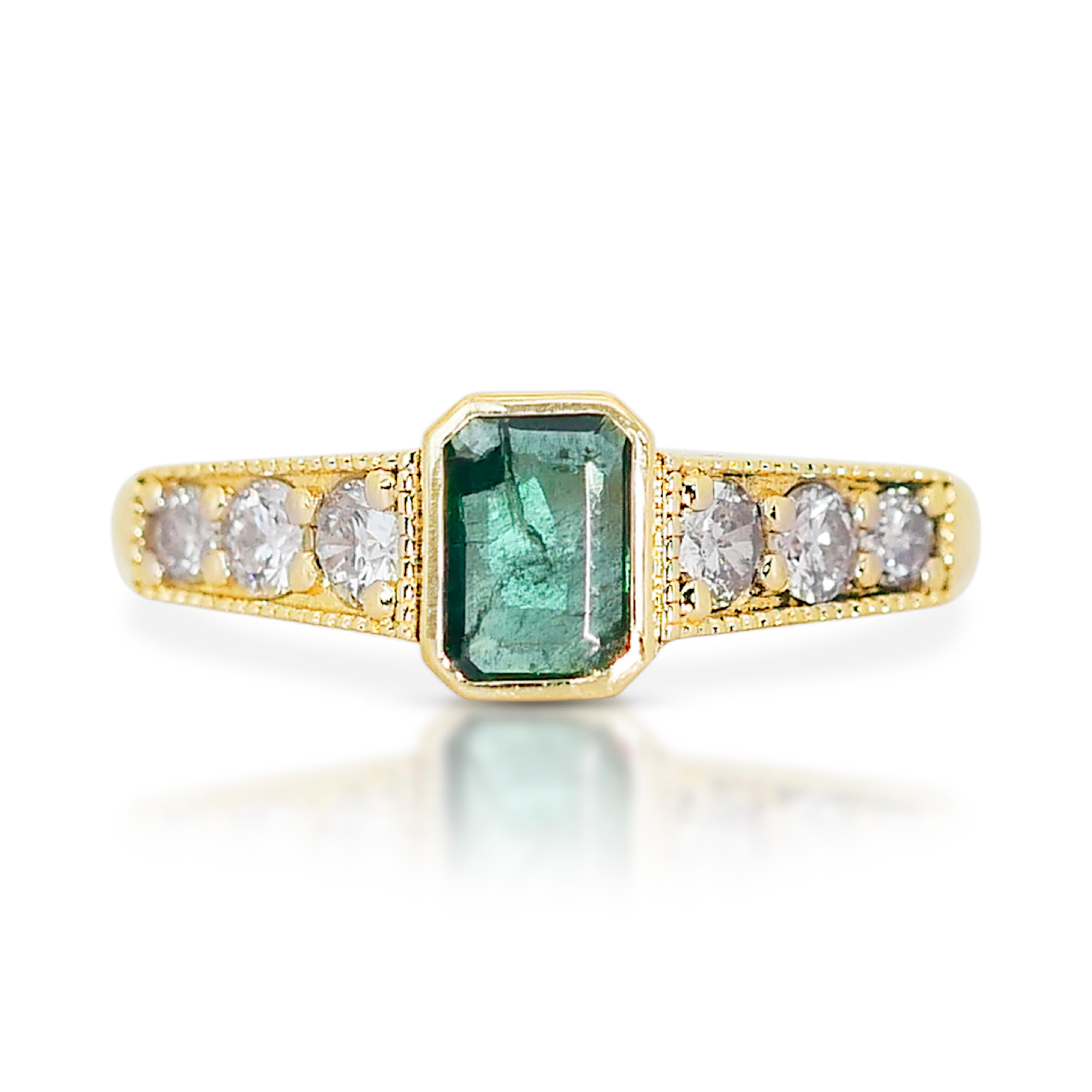 Enchanting 14k Yellow Gold Emerald and Diamond Pave Ring w/0.89 ct - IGI Certified

This enchanting ring, crafted in glowing 14k yellow gold, features a beautiful combination of a captivating emerald and sparkling diamonds. The centerpiece is a