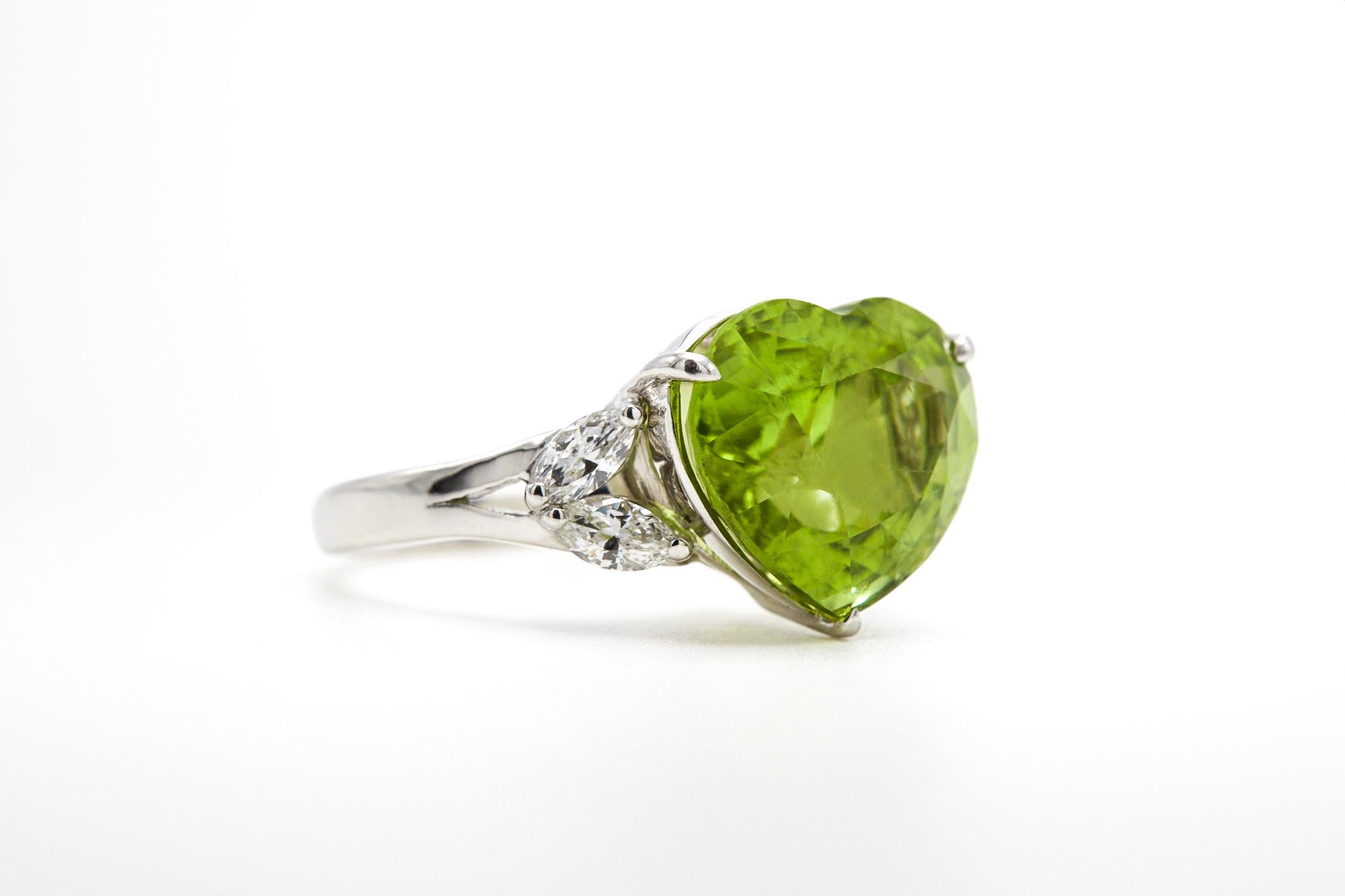 Experience a love that knows no bounds with our captivating Peridot Heart Ring—the 7.62 carat heart-shaped green peridot ring, sourced from the renowned mines of Mogok in Burma. This untreated Peridot, with its elegantly playful green hue and