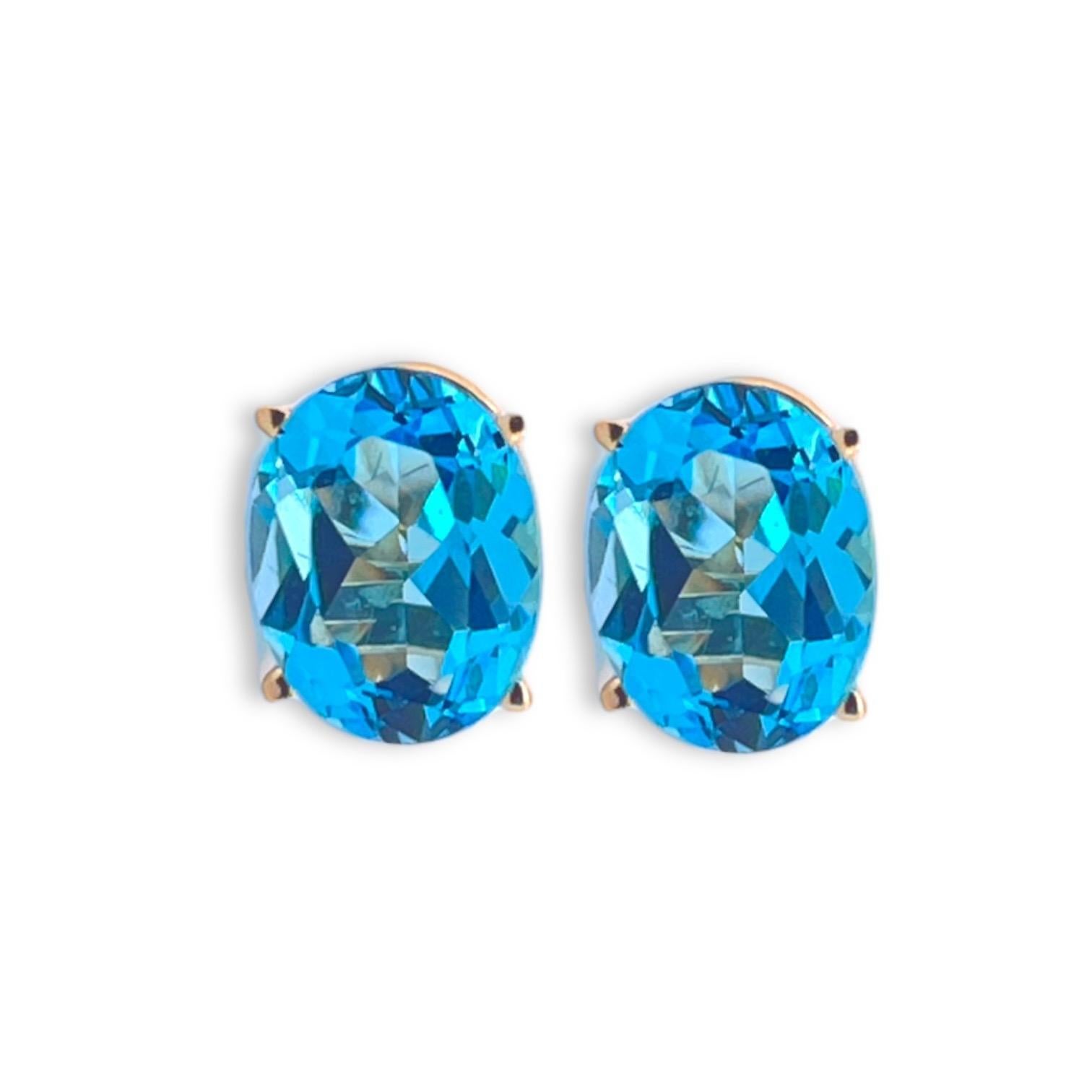 Immerse yourself in the serene beauty of our Enchanting Azure Bliss Oval Blue Topaz Stud Earrings, exquisitely crafted with the finest 14K yellow gold. Each earring, weighing 1.86 grams, features an impeccably cut oval blue topaz, a gemstone