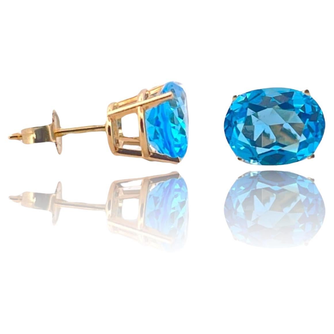 Enchanting Azure Bliss Oval Blue Topaz Studs in 14K Yellow Gold For Sale