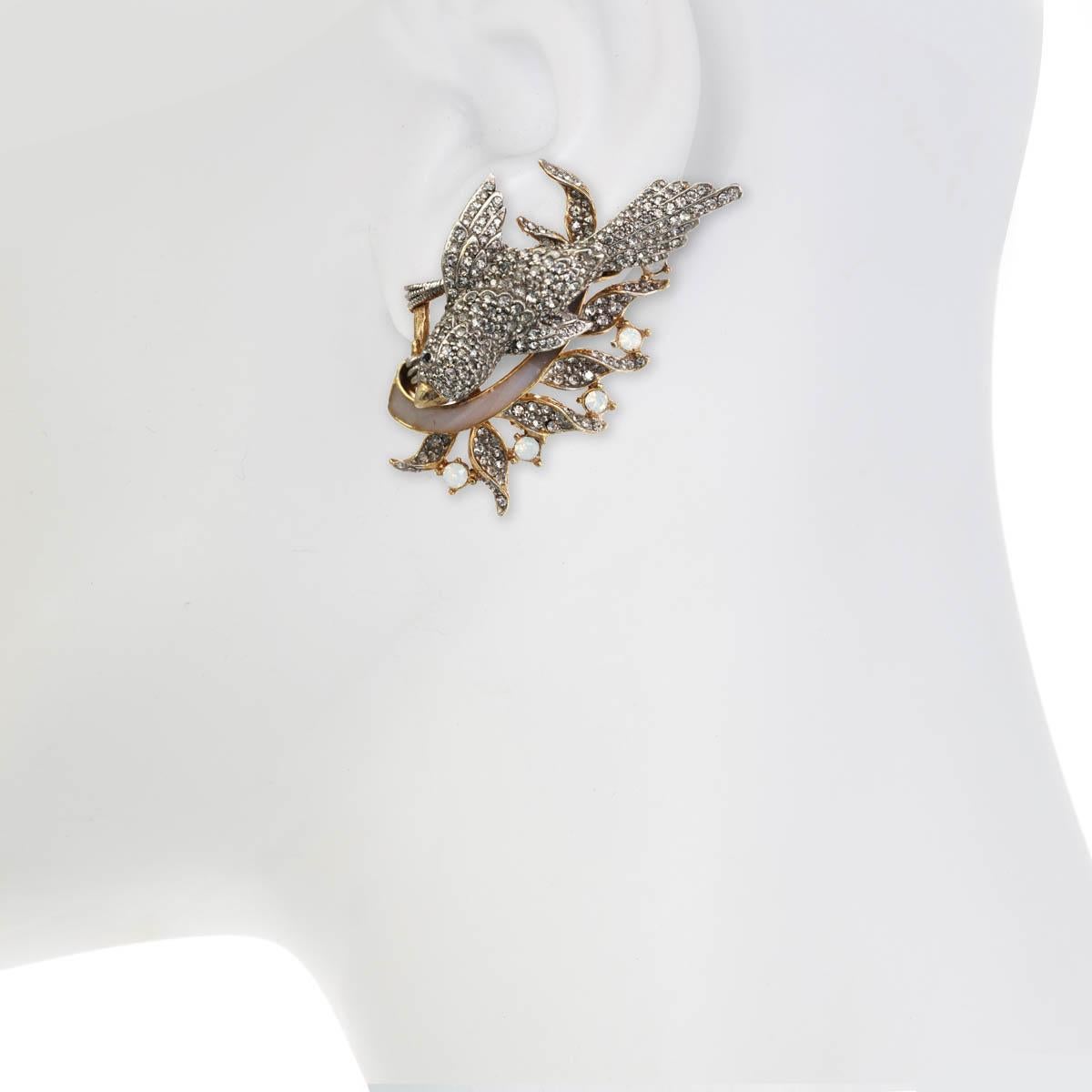 The Enchanting Bird Earring, from season I of the Ines x Ciner collaboration, is as sweet as can be with its beautiful rhinestone accents.

Materials: 
Pewter
18K Gold Plating
Genuine Rhodium Plating
Opal Enamel
Clip Back
Dimensions: 
Length: 2