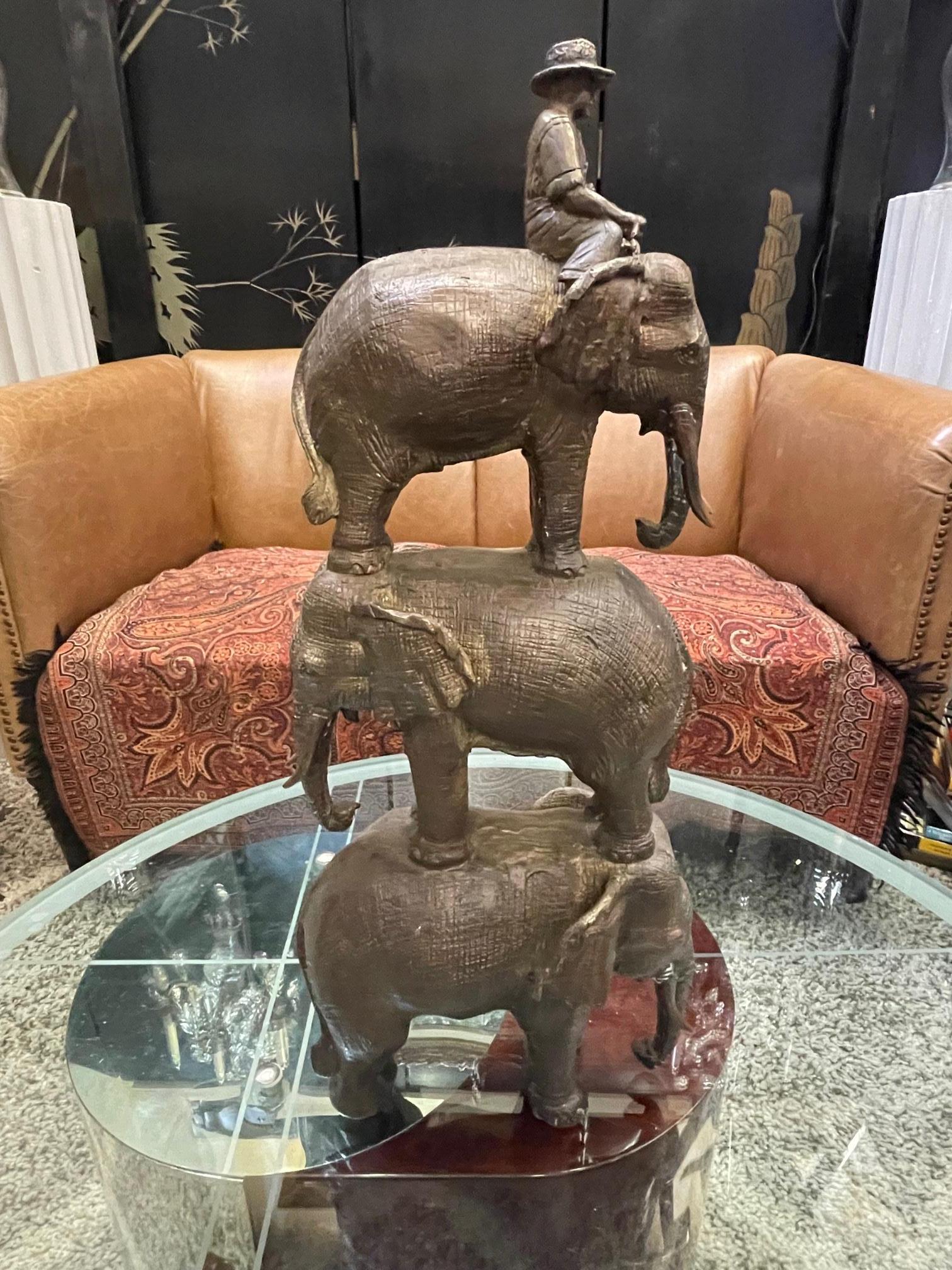 Indonesian Enchanting Bronze Sculpture of a Man Riding Three Elephants For Sale