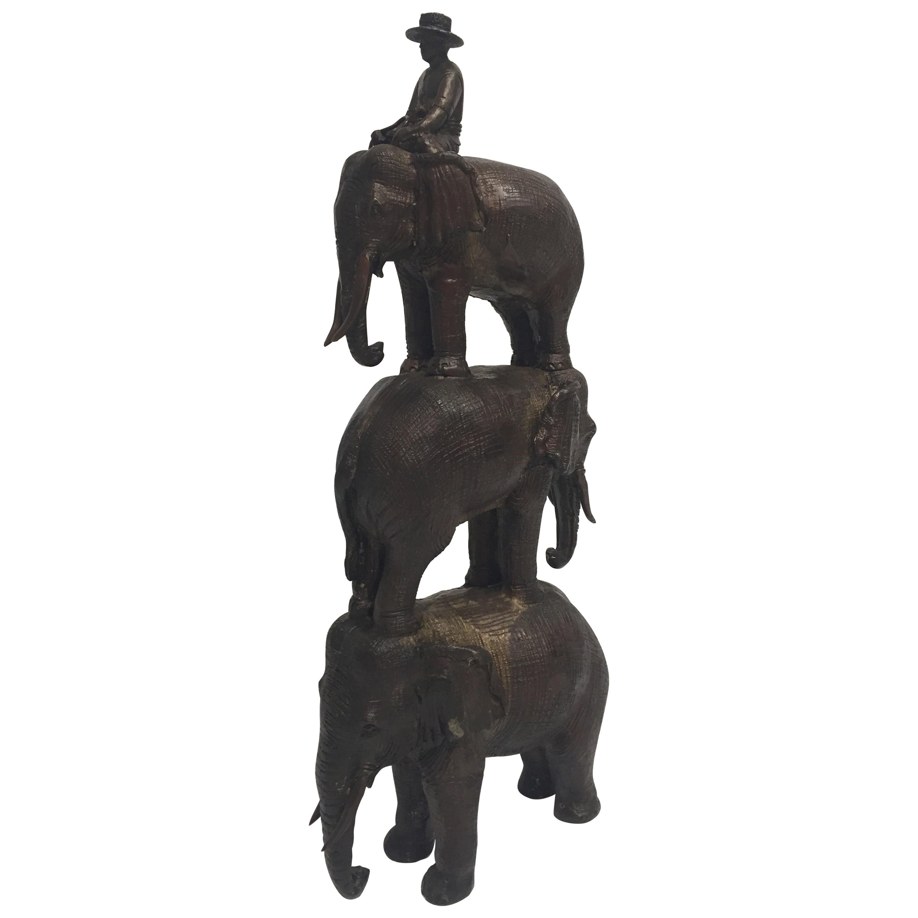 Enchanting Bronze Sculpture of a Man Riding Three Elephants