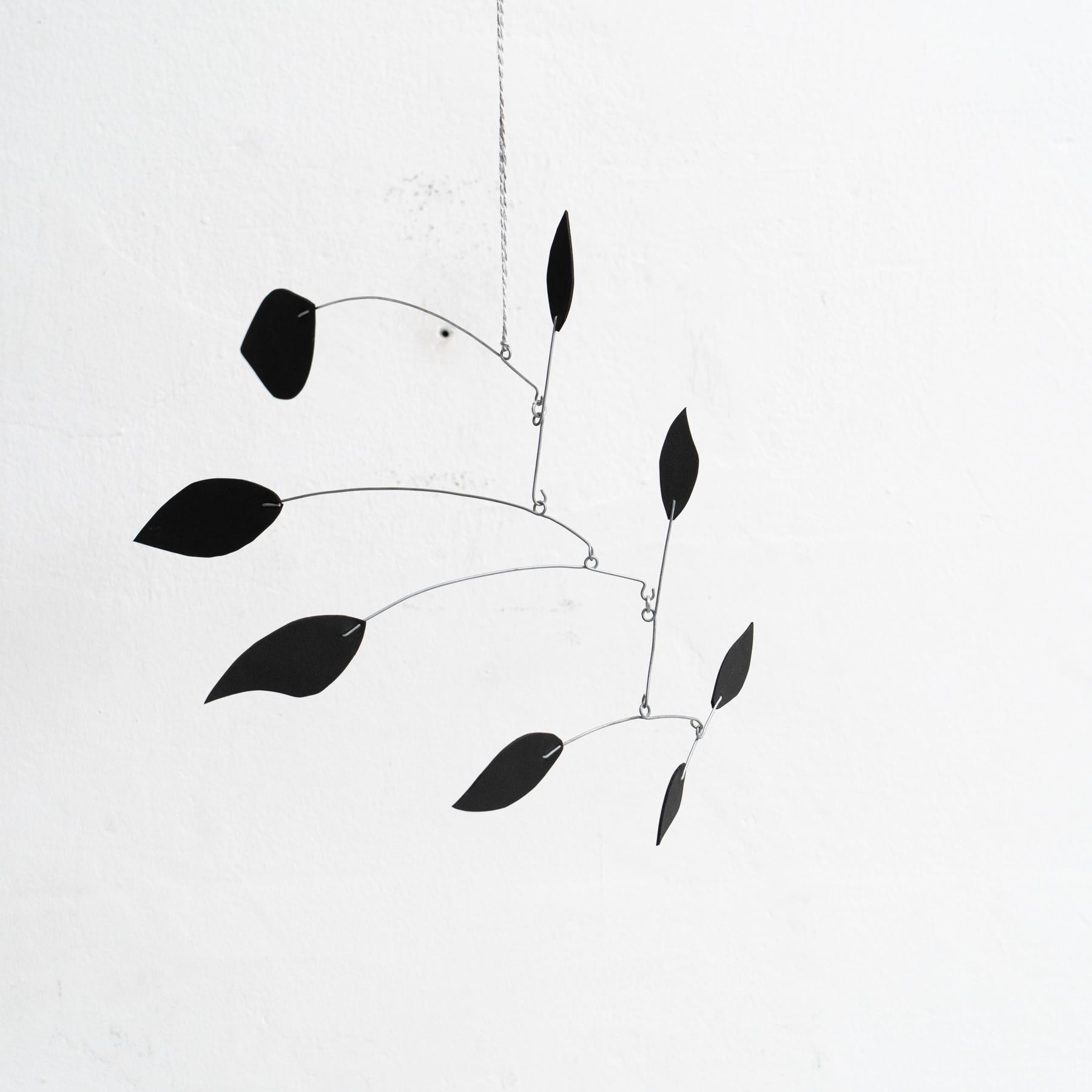 Originating from France and created around 1990 by an unknown artist, this captivating kinetic sculpture embodies the essence of motion and creativity. Constructed from a combination of iron and foam, and finished entirely in an elegant black hue,