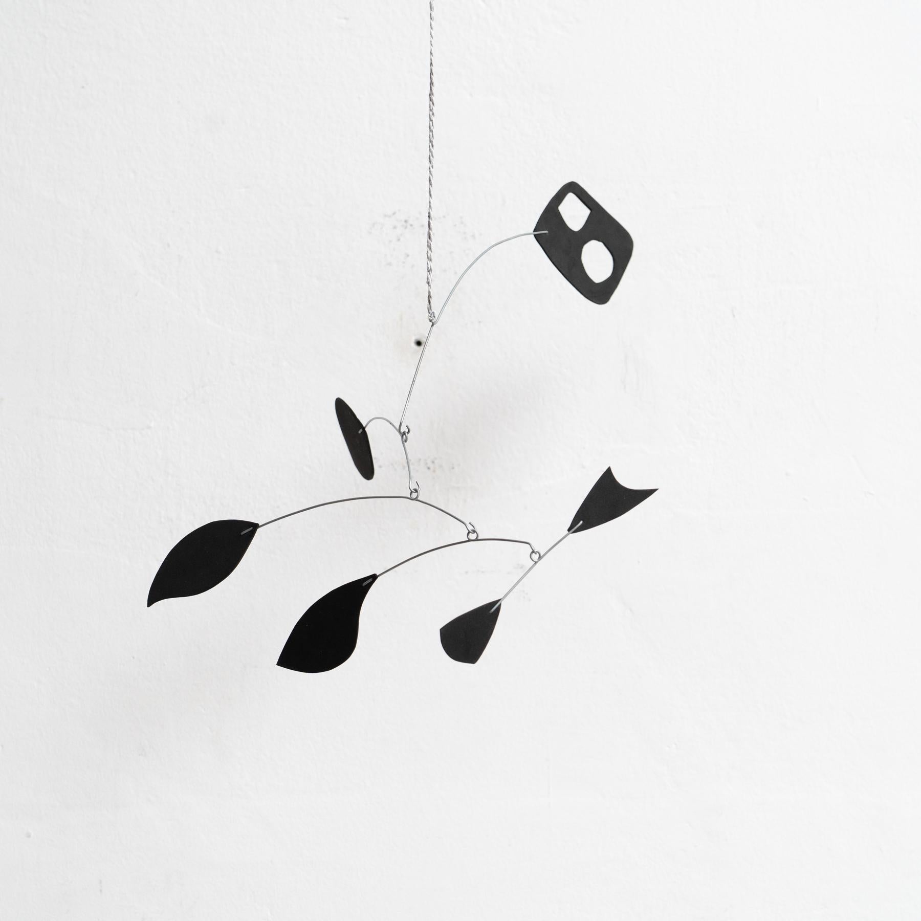 Originating from France and created around 1990 by an unknown artist, this captivating kinetic sculpture embodies the essence of motion and creativity. Constructed from a combination of iron and foam, and finished entirely in an elegant black hue,