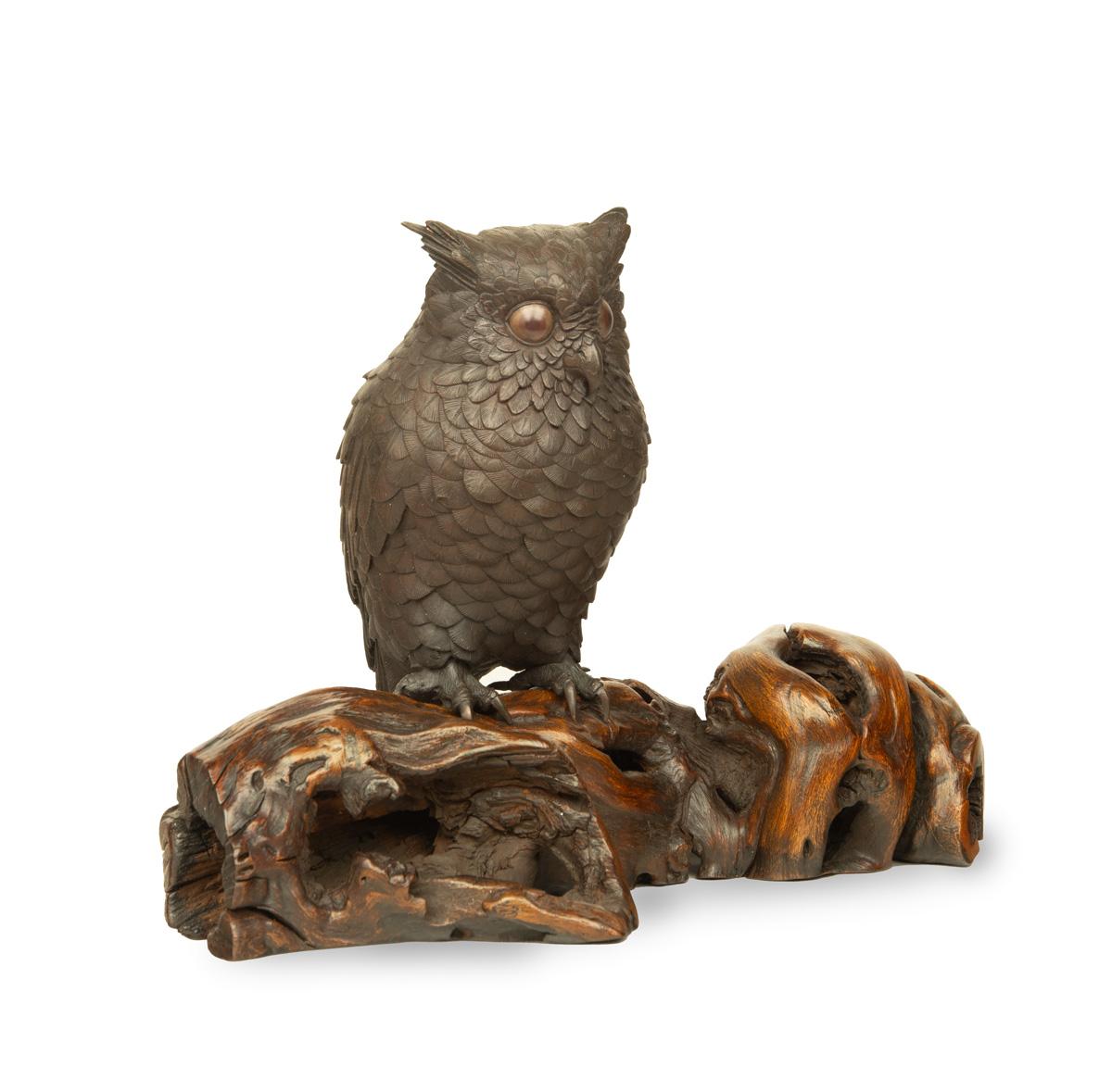 As part of our Japanese works of art collection we are delighted to offer this most enchanting Meiji Period (1868-1912), bronze okimono depicting a long eared owl upon a rootwood branch, the unknown artist has captured the majestic bird in very fine
