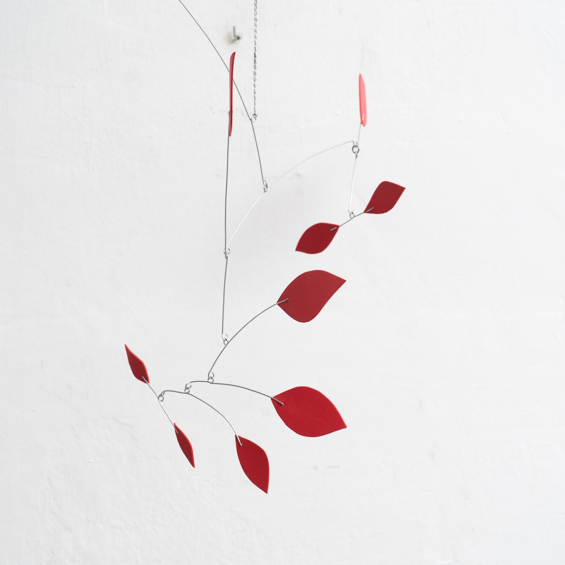 Originating from France and created around 1990 by an unknown artist, this captivating kinetic sculpture embodies the essence of motion and creativity. Constructed from a combination of iron and foam, and finished entirely in a striking red hue, it