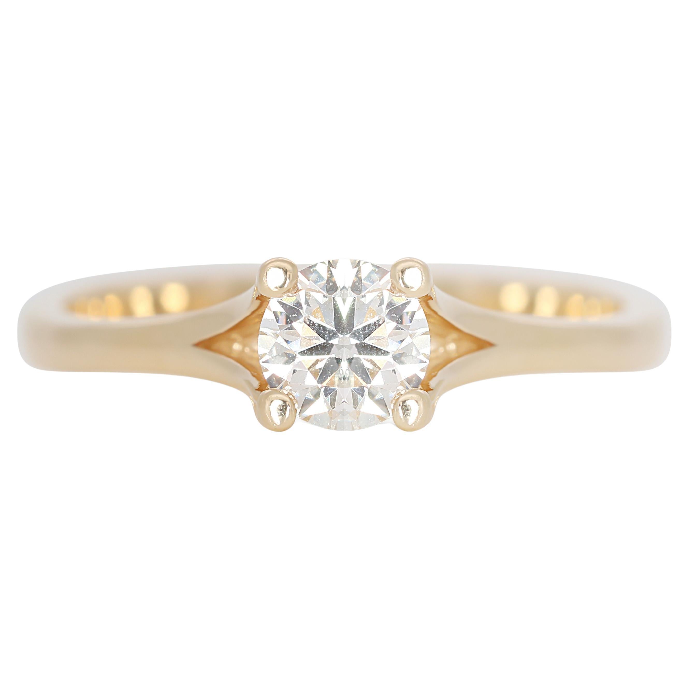 Enchanting Solitaire: 0.38 ct Diamond Shimmers in Warm 14K Gold For Sale