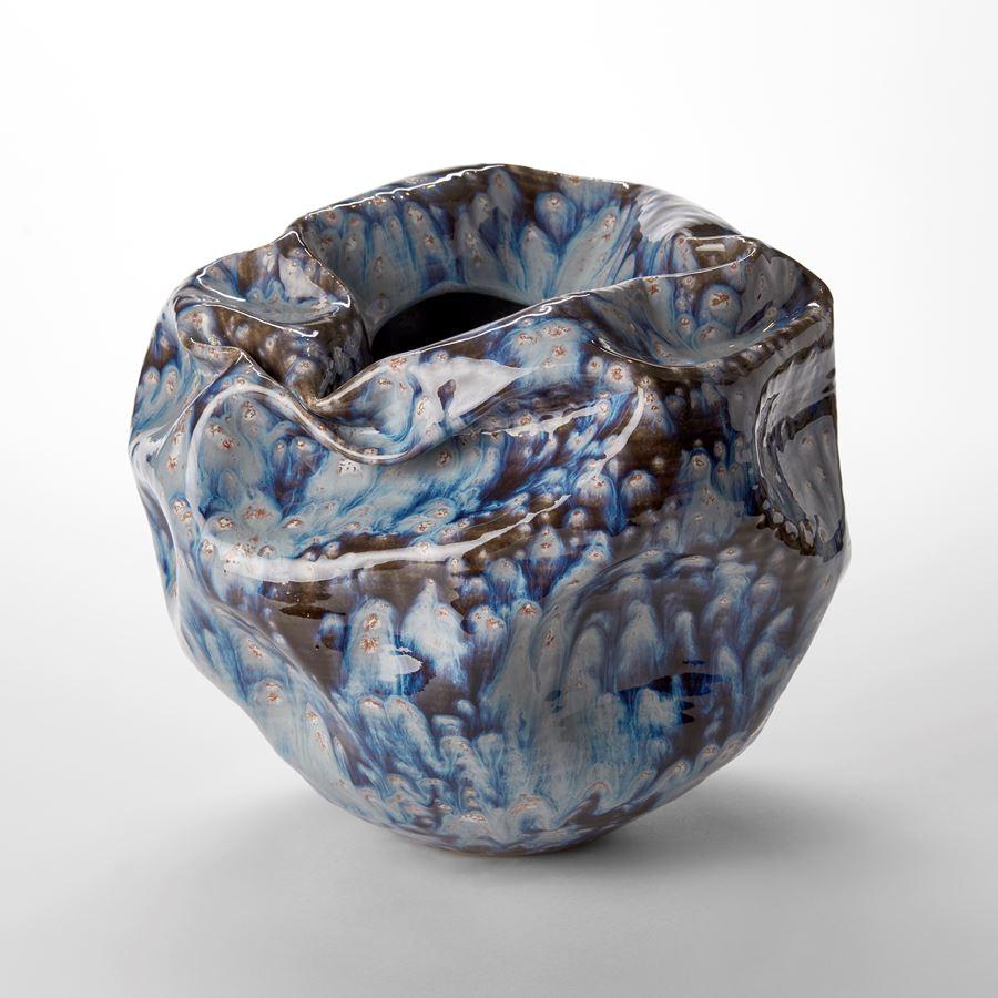 ‘Enclosed Form in Galactic Blue No 111’ is a unique sculptural vessel by the British artist, Nicholas Arroyave-Portela.

Nicholas Arroyave-Portela’s professional ceramic practise began in 1994. After 20 years based in London, he moved and set up his