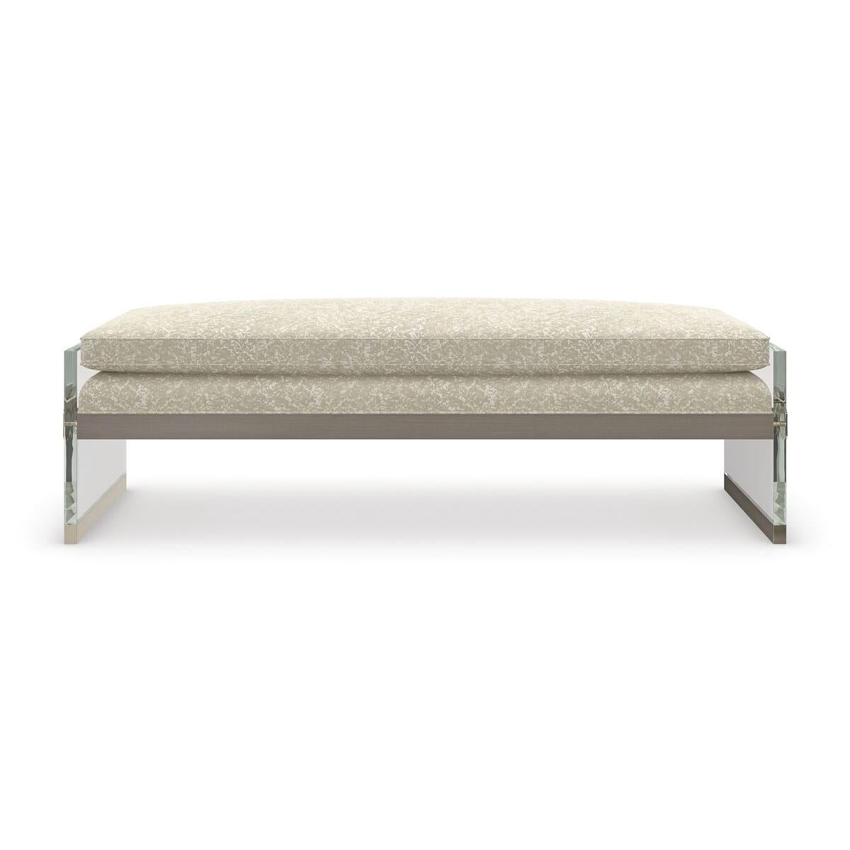 A lavish landing for the end of bed, this bench introduces a note of luxury to bedrooms, powder rooms, and dressing areas. Suspended between two clear acrylic panels, a plush cushioned bench seat beckons in a textured chenille fabric with a lustrous