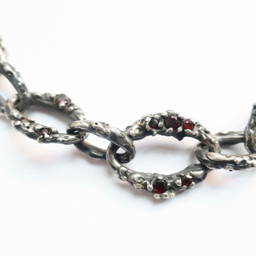 Hand fabricated chain in sterling silver with a range of 2-4mm garnets set in hand cast sterling silver links. This piece is absolutely stunning with 3 varying link sizes soldered together creating this unique and one of a kind heirloom piece. This