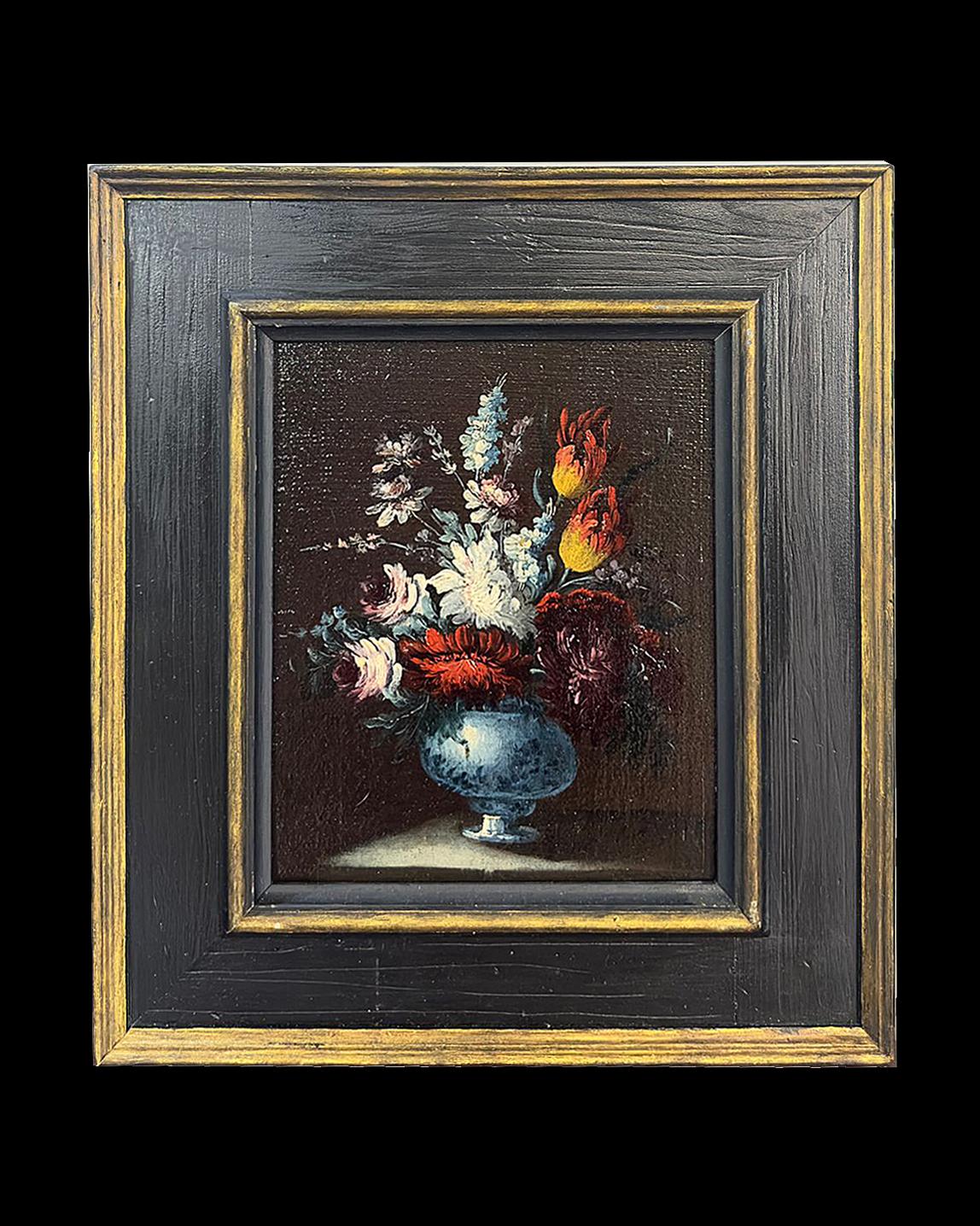 Beautiful pair of oil paintings on canvas, mounted on panel and framed in ebonized and gilded wood. The pictorial technique used favors chiaroscuro, with the representation of a vase with various types of flowers in the centre. These paintings, the