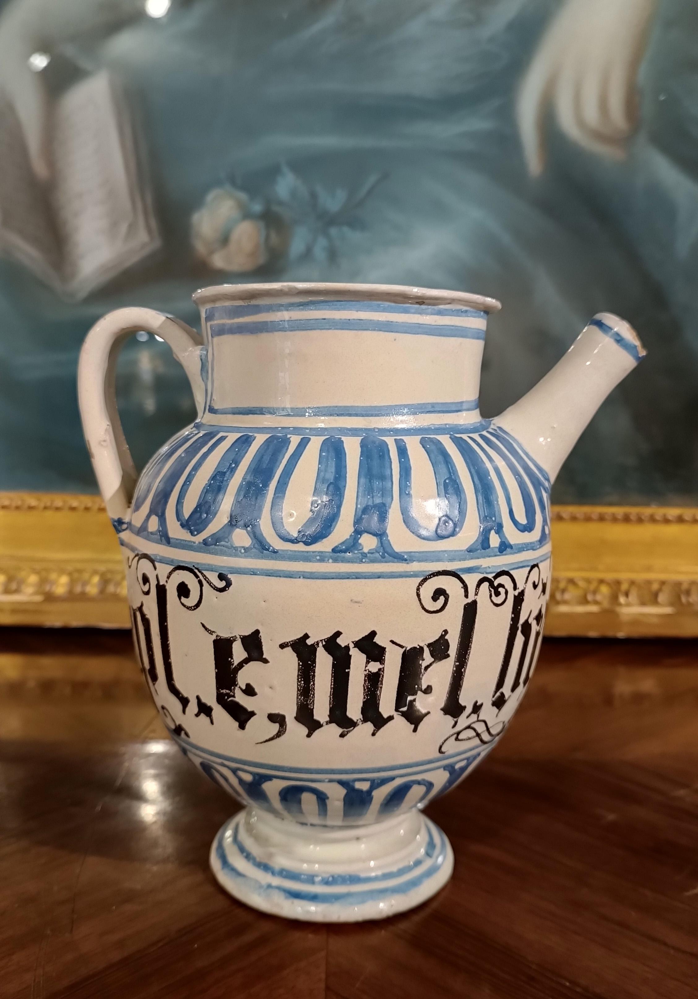 Beautiful blue and white glazed majolica jug, made in Faenza at the end of the 17th century. The jug is decorated with motifs painted in blue that recall the style of archaic majolica of the thirteenth and fourteenth centuries, with spirals and