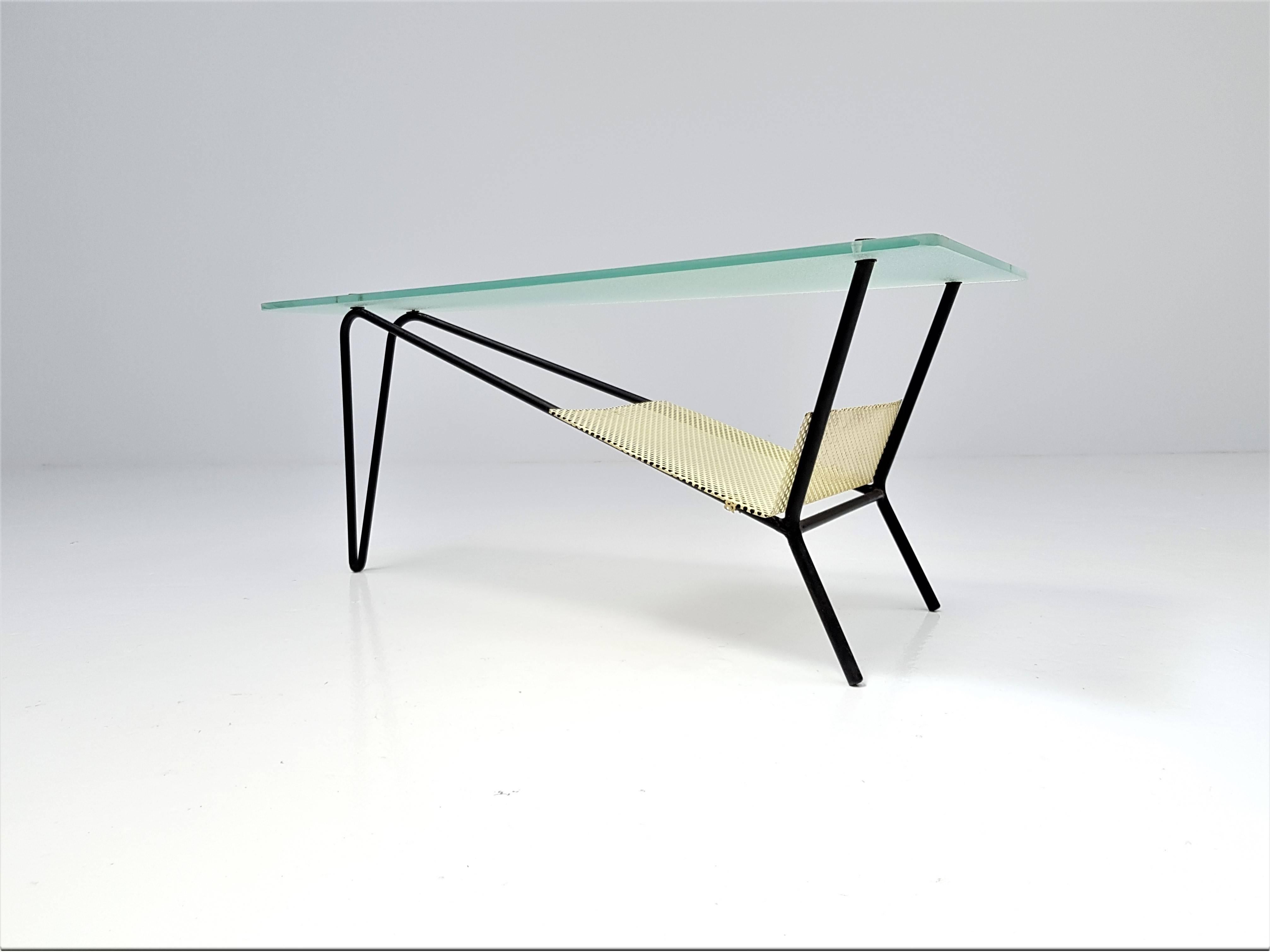 An end table by Robert Mathieu, France, circa 1955

An end table by Robert Mathieu, circa 1955. Consisting of a lacquered black tubular structure, a sandblasted glass top, brass fixings and a perforated tray. 

Robert Mathieu is recognised as an