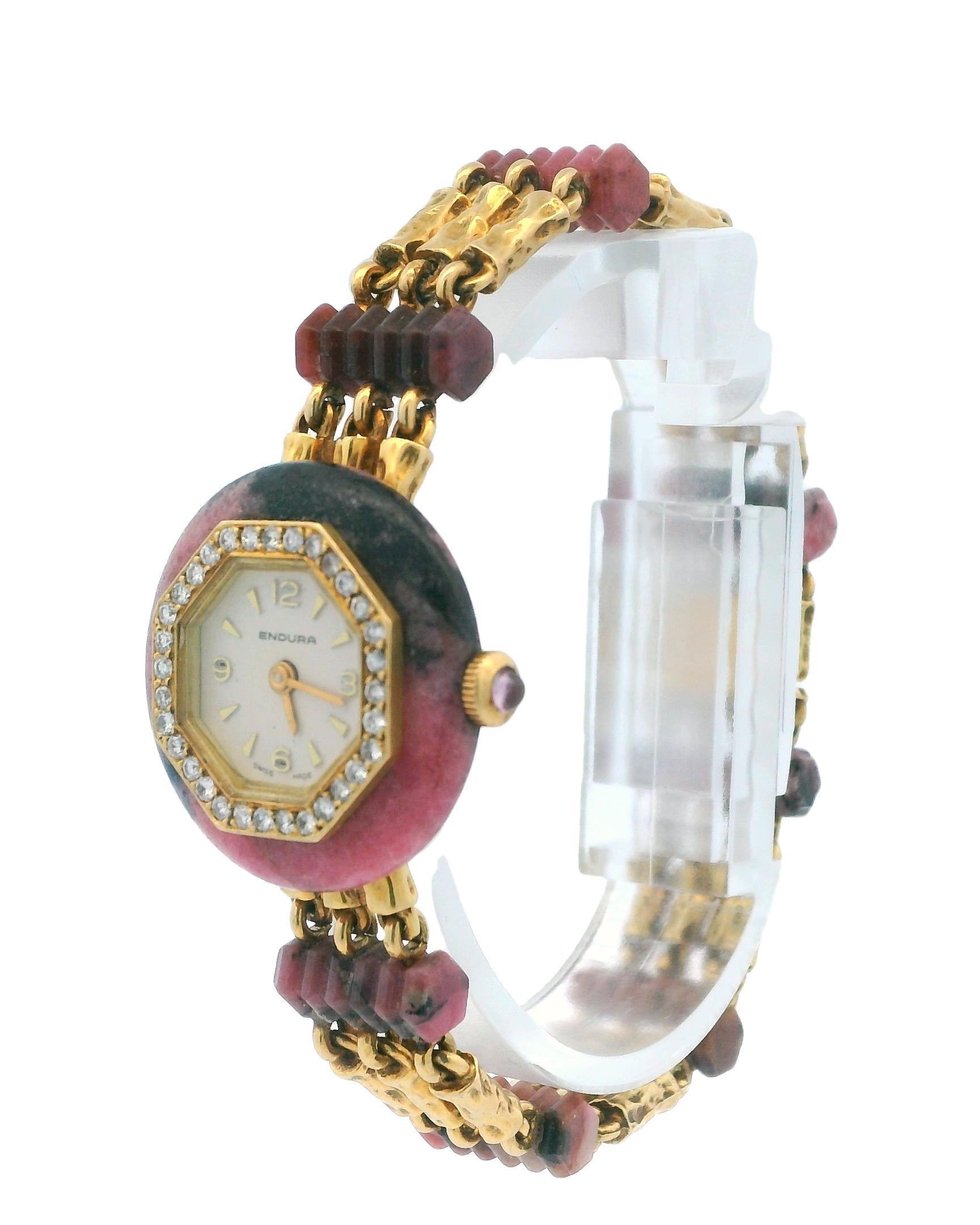 A distinctive and elegant watch featuring a round face with a 23mm silver dial adorned with stick indexes.

The watch is encircled by a diamond bezel, adding a touch of luxury to its design. The case showcases a multicolor finish, enhancing its