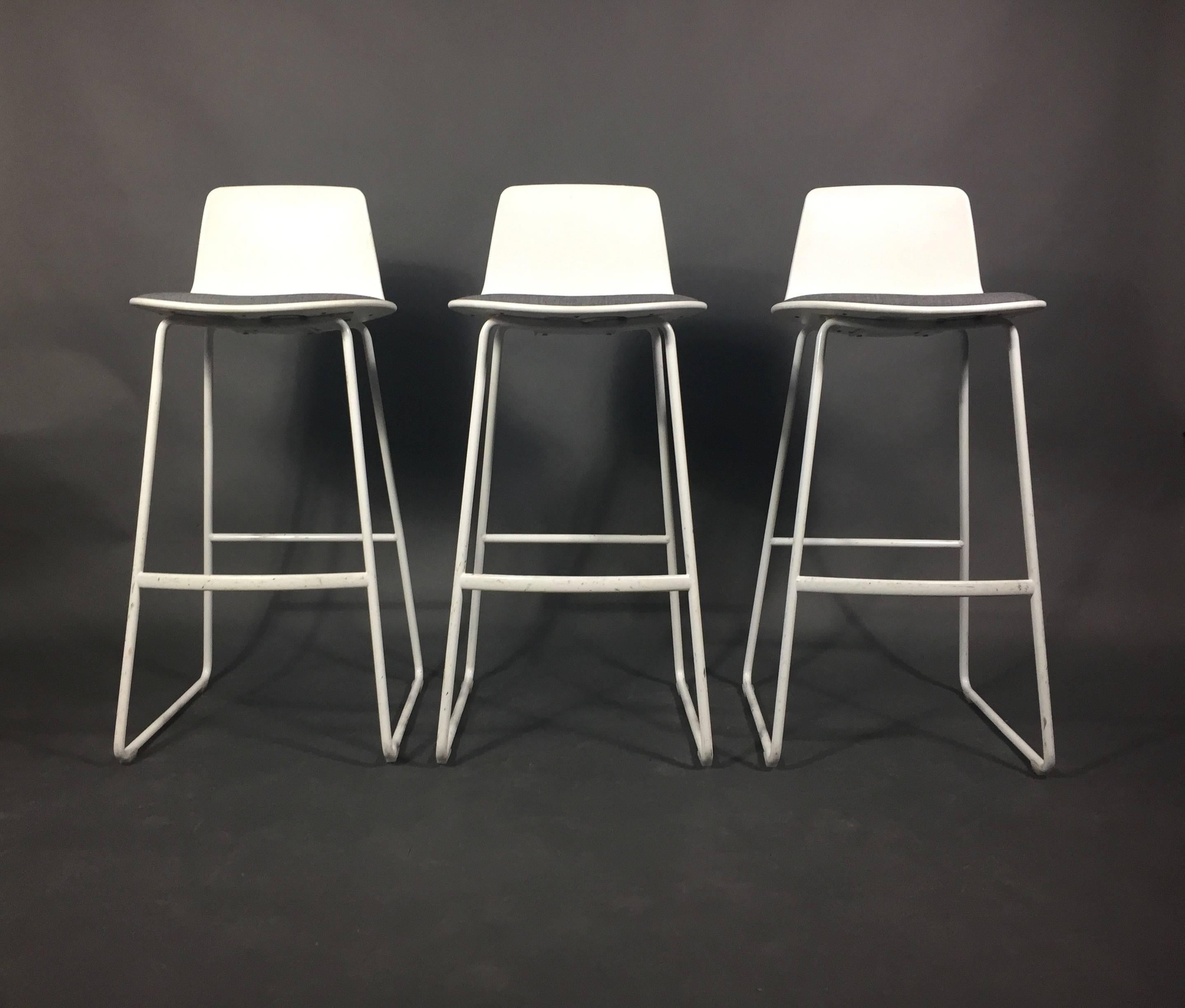Enlightened contemporary design from the Lievore Altherr Molina studio in Barcelona. Sculpted plastic back on white lacquered frames with recently updated Danish gray upholstery fabric. 2011 production. Set of three. Made in Spain. Wear to frames.