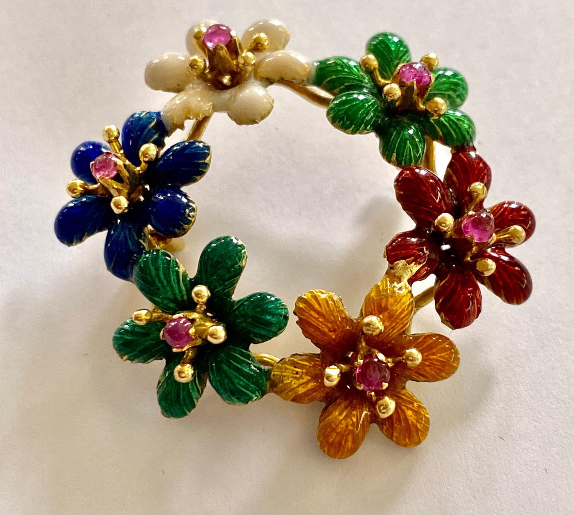 One (1) 18 Karat Yellow Gold Brooch, stamped 750,  decorated with Yellow, Red, Green, White, Blue and Bluish Green Enemal.
set with 6 (six) Natural Corundum, Pink Sapphire stones in cabuchon  shape cutting.
Weight of the Sapphires: 0.50ct.  (No